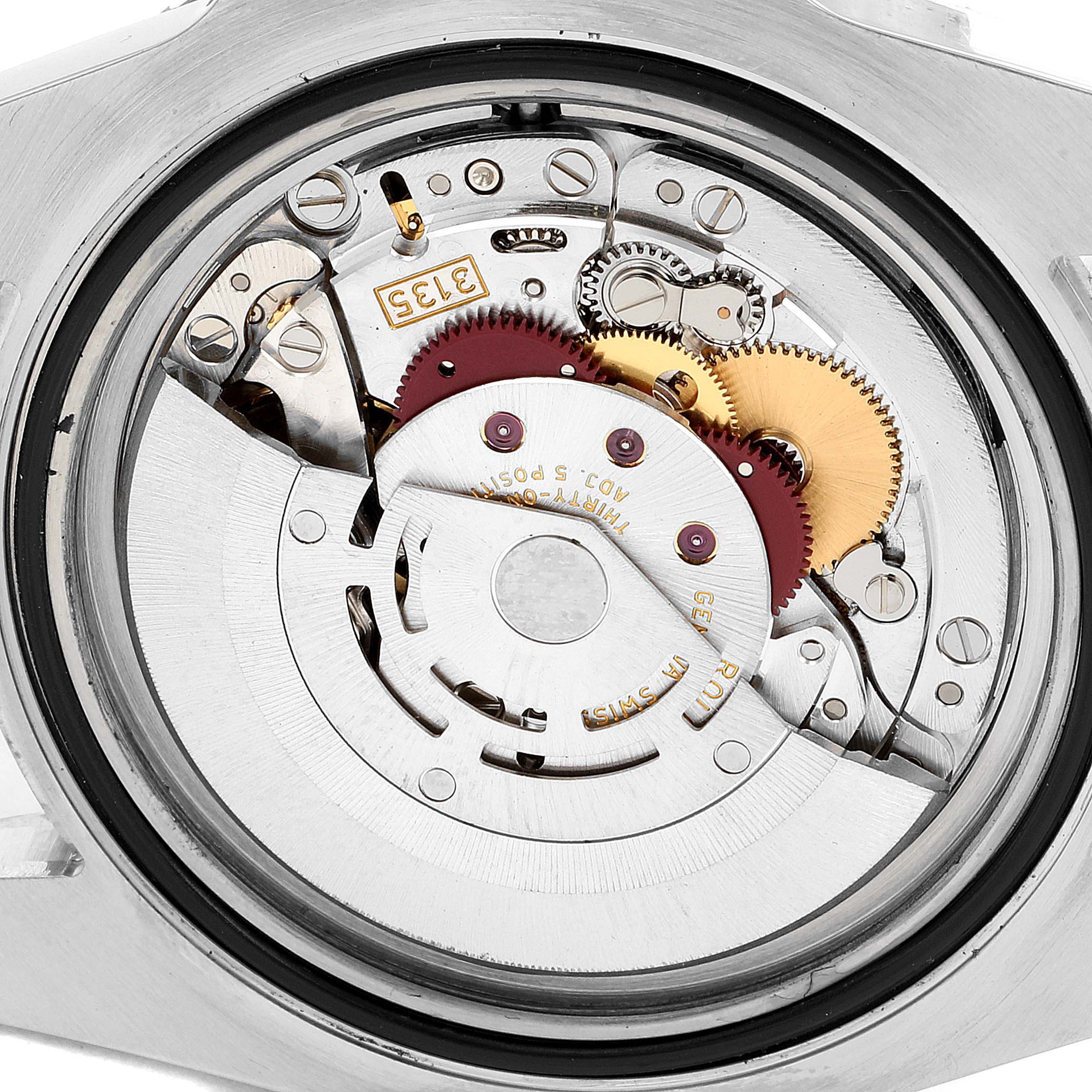 This image shows the internal mechanism of the Rolex Submariner 116613 Men's Steel and Gold (two tone) Blue Dial 116613 Men's Steel and Gold (two tone) Blue Dial watch from the back angle, revealing gears and movement parts.