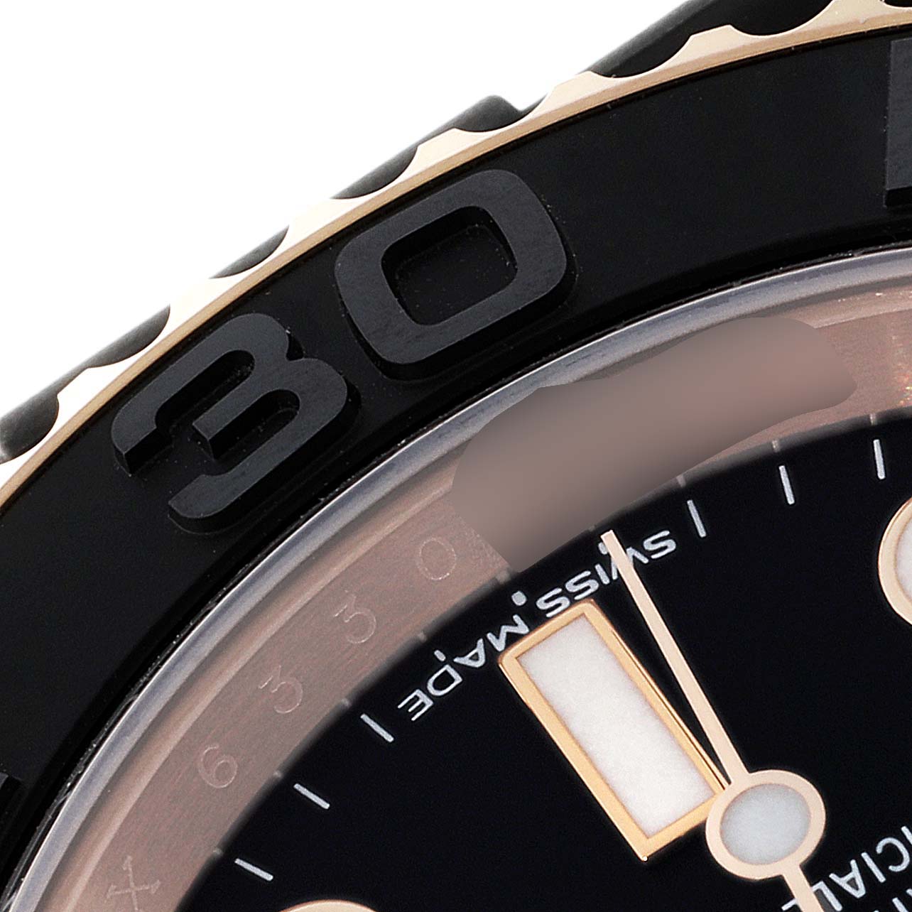 This close-up image of the Rolex Yacht-Master 116655 Men's Rose Gold Black Dial 116655 Men's Rose Gold Black Dial watch shows part of the bezel and a section of the dial.