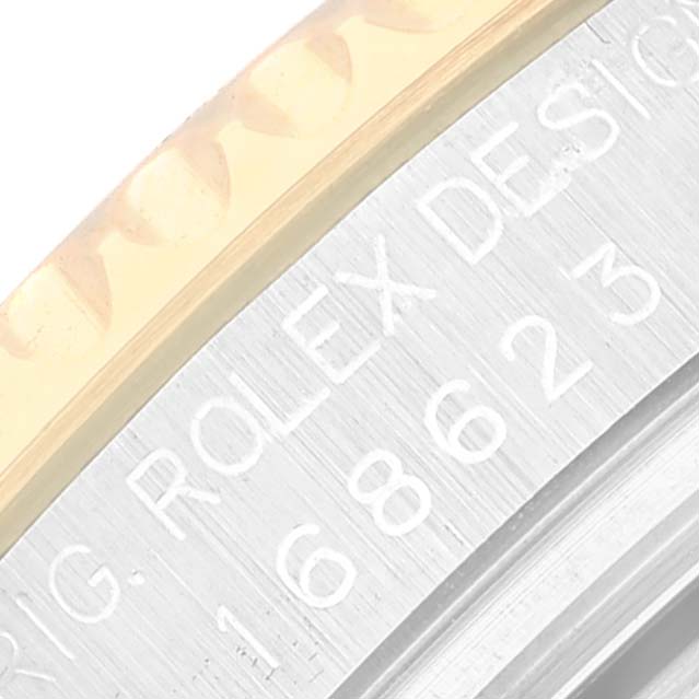 Close-up of the serial number engraving on the side of the Rolex Yacht-Master 168623 Men's Steel and Gold (two tone) Grey Dial 168623 Men's Steel and Gold (two tone) Grey Dial watch bezel and case.