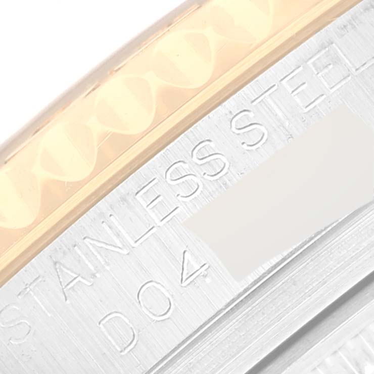 This close-up image shows a portion of the bezel and engraved details on the caseback of a Rolex Yacht-Master 168623 Men's Steel and Gold (two tone) Grey Dial 168623 Men's Steel and Gold (two tone) Grey Dial watch.