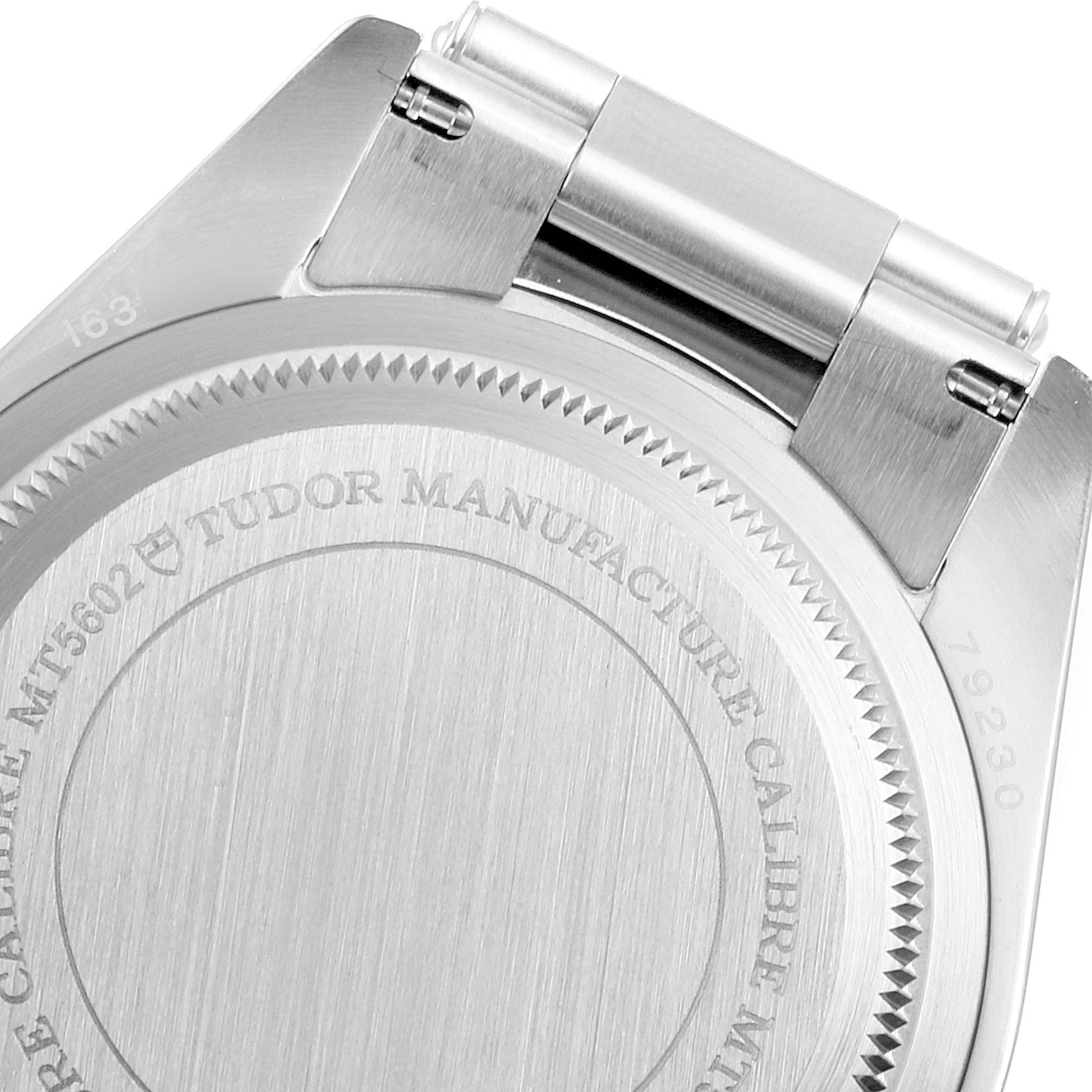 The image shows the case back and bracelet attachment of the Tudor Heritage Black Bay 79230R Men
s Stainless Steel Black Dial 79230R Men
s Stainless Steel Black Dial watch, featuring engraved text.