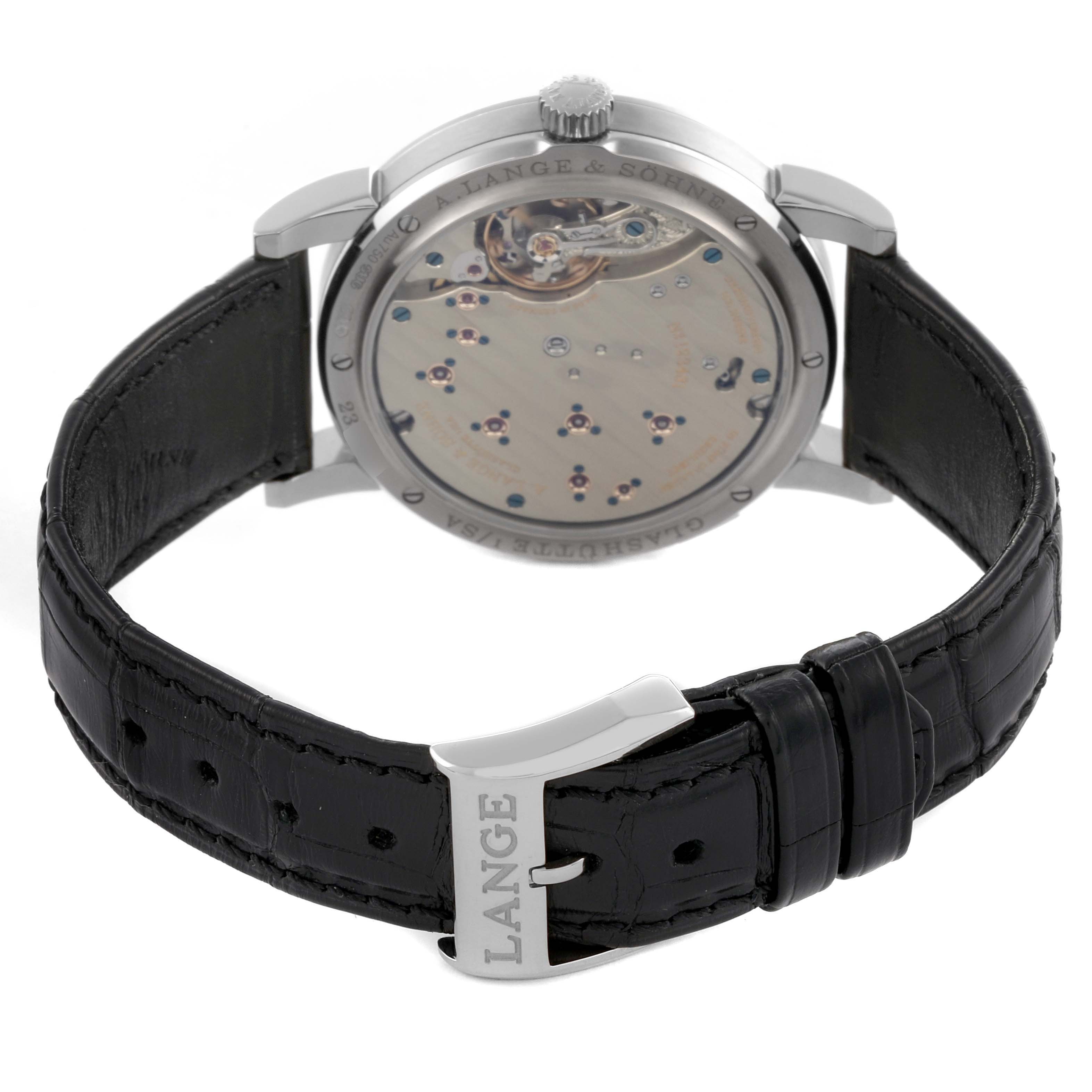 The image shows the back case and leather strap of the A. Lange 
Sohne Lange 1 191.039 Men
s White Gold Silver Dial watch at an angle displaying the movement.