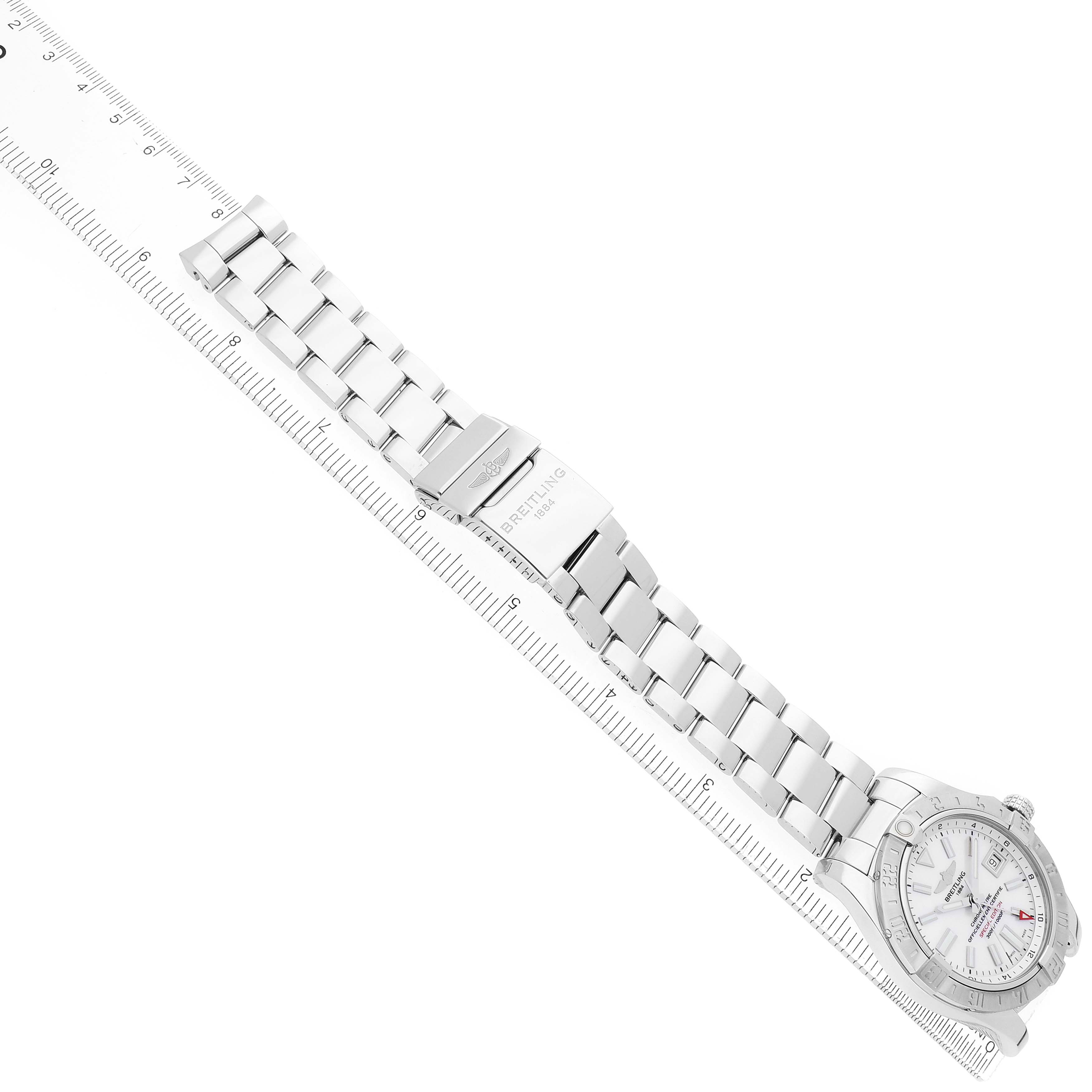 The Breitling Avenger A3239011/A809 Men's Stainless Steel Mother of Pearl Dial watch is shown at a slight angle, highlighting the face, bracelet, and clasp, along with a ruler for scale.