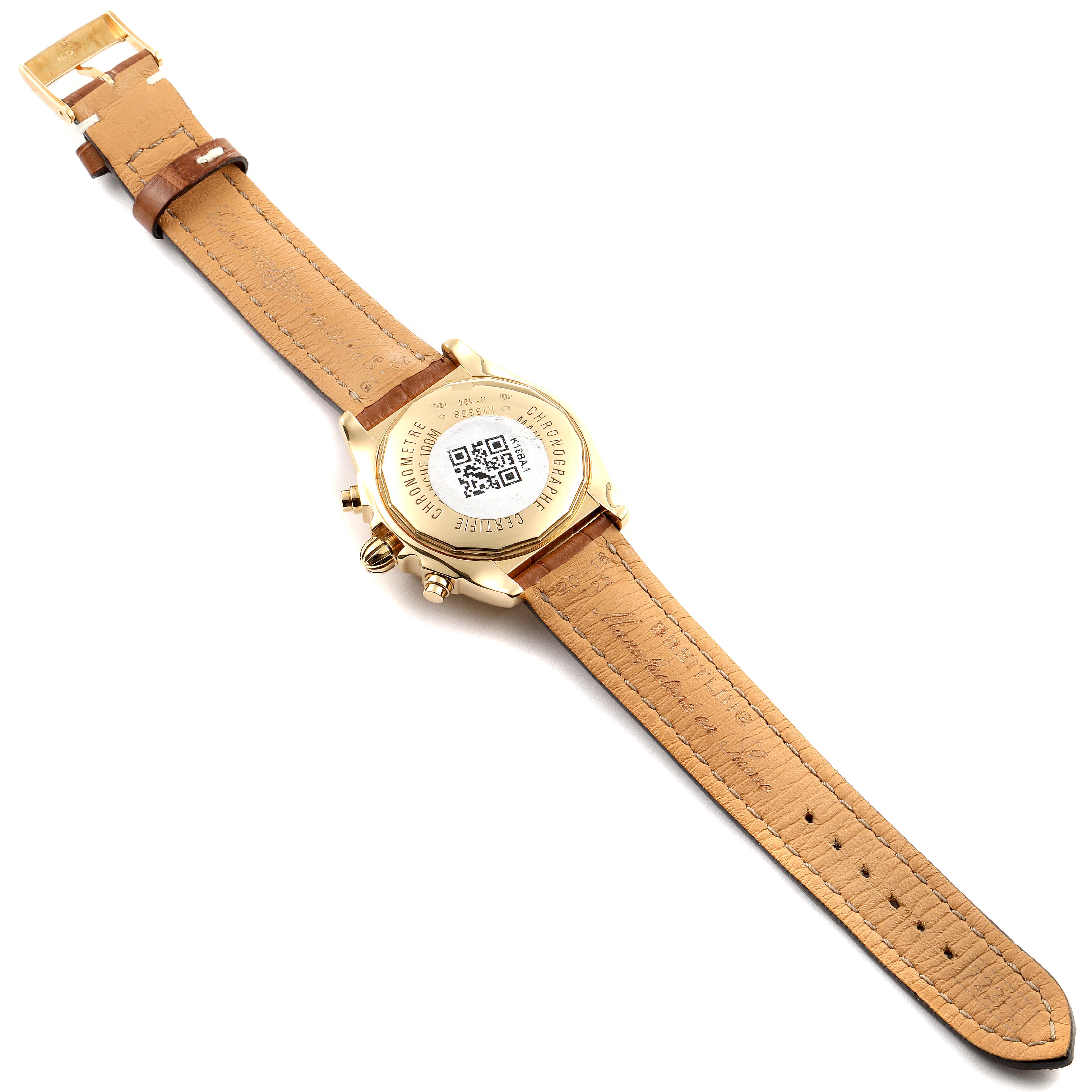 The image shows the back view of a Breitling Chronomat K13358 Men's Yellow Gold Mother of Pearl Dial K13358 Men's Yellow Gold Mother of Pearl Dial watch with a tan leather strap fully extended.