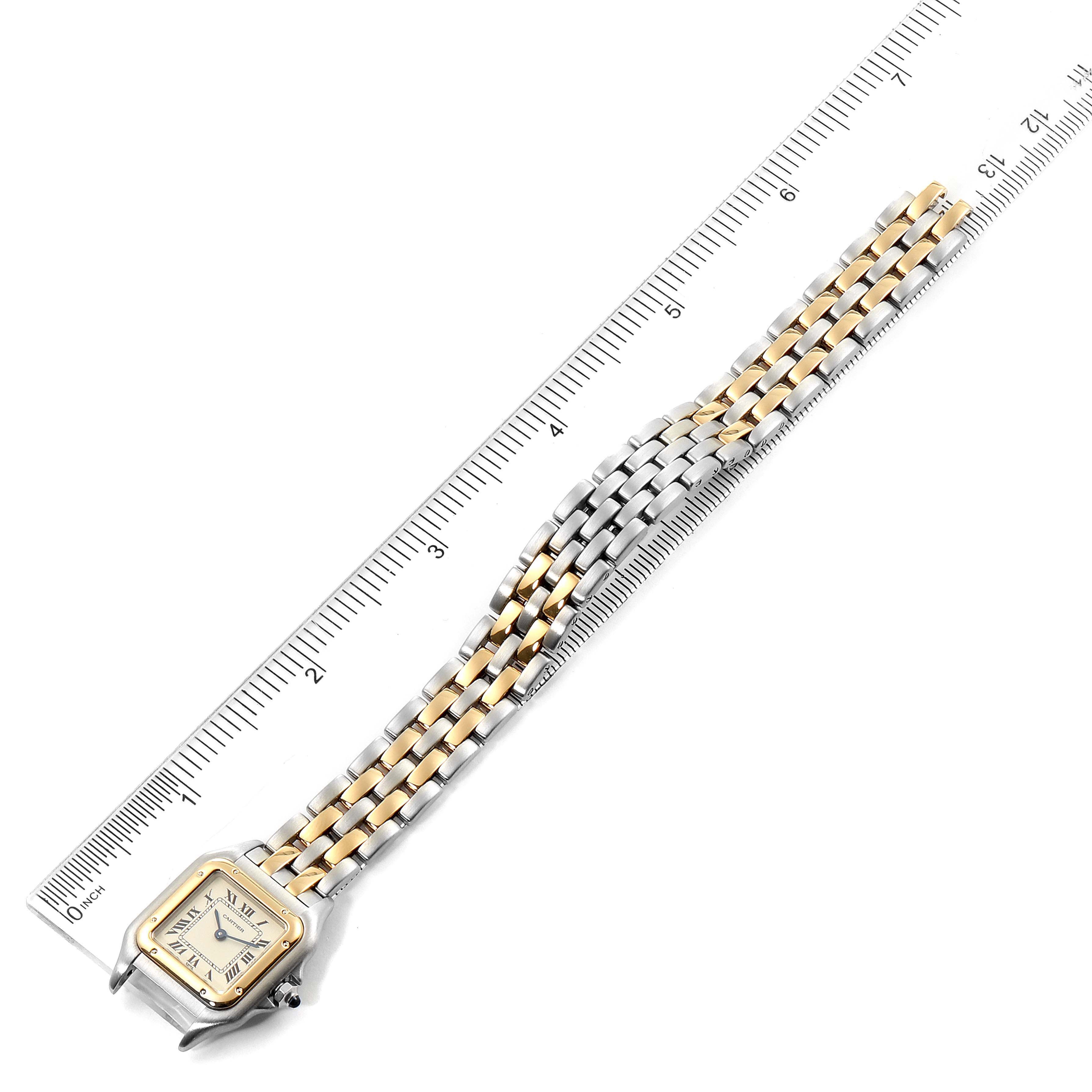 The image shows an overhead view of a Cartier Panthère watch with its gold and silver bracelet placed next to a ruler.
