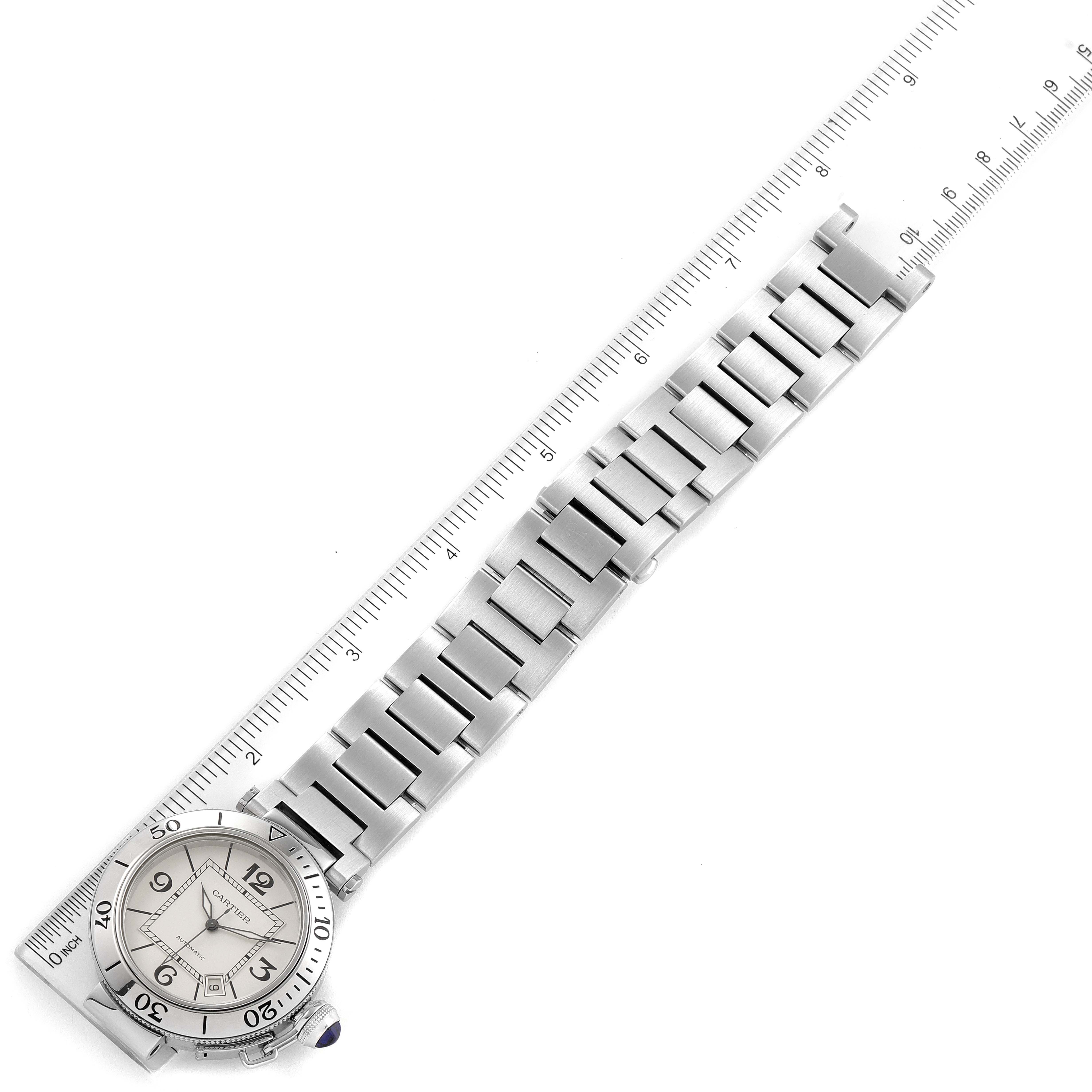 This image shows the face and band of the Cartier Pasha W31080M7 Men
s Stainless Steel Silver Dial W31080M7 Men
s Stainless Steel Silver Dial watch, laid out flat next to a ruler for size reference.