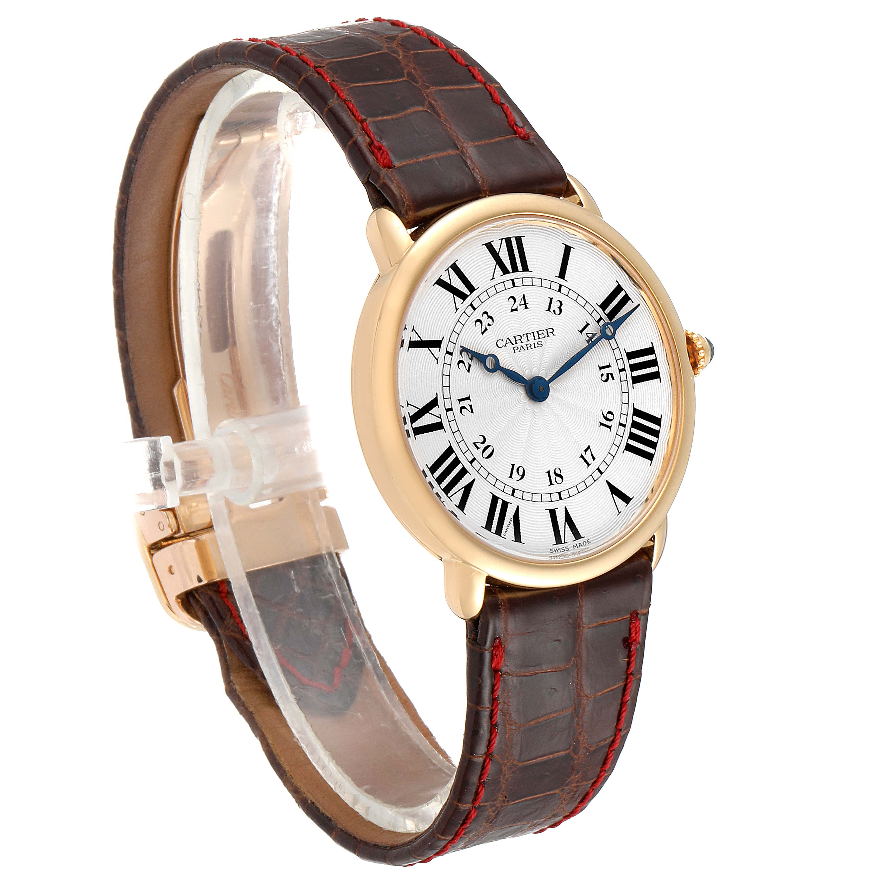 This image shows a Cartier Ronde 0900 Men's Yellow Gold Silver Dial 0900 Men's Yellow Gold Silver Dial watch featuring a gold case, leather strap, and Roman numeral dial, viewed from an angled side perspective.