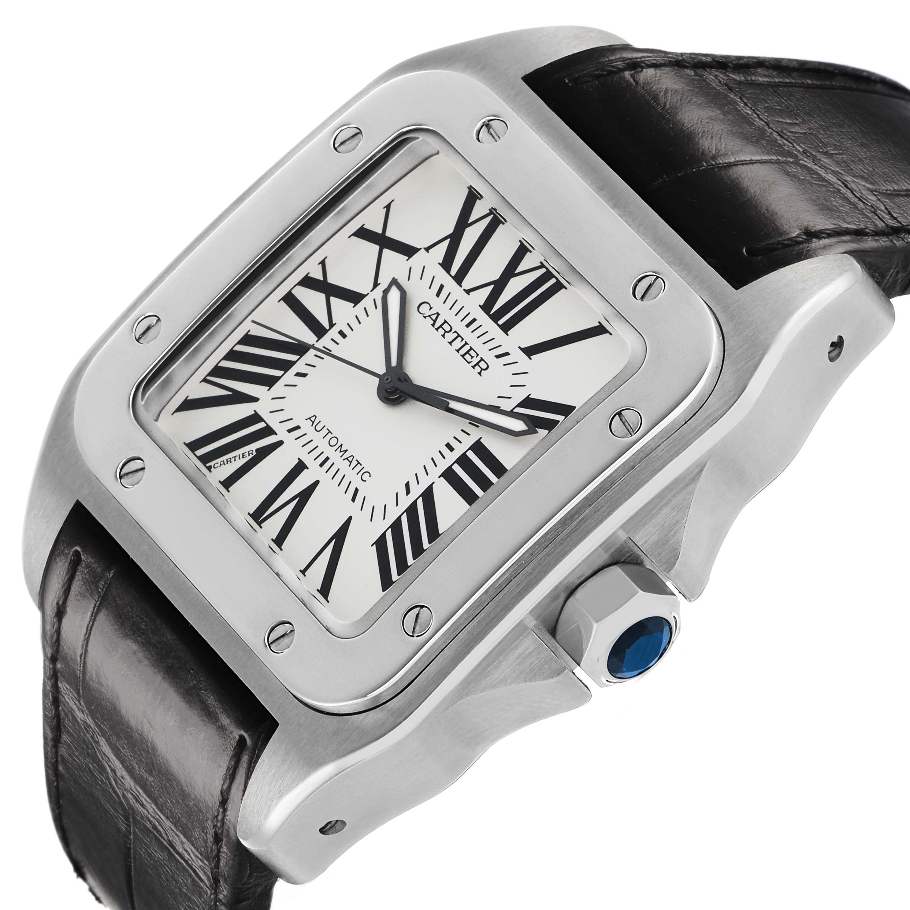 The Cartier Santos W20073X8 Men's Stainless Steel Silver Dial watch is shown at an angled side view, highlighting the case, bezel, crown with a blue stone, and part of the strap.