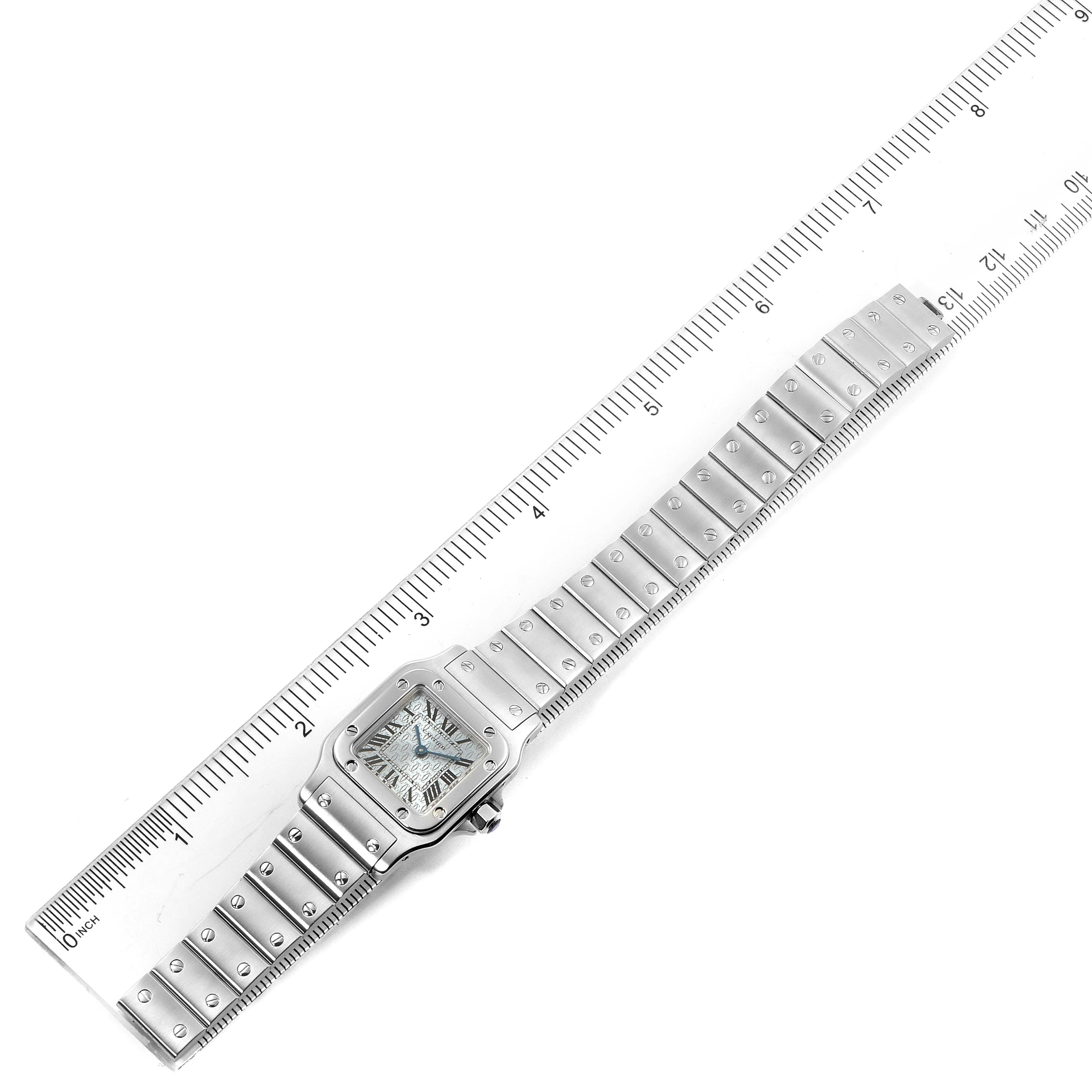 The image shows a Santos model by Cartier laid flat with the entire watch and bracelet visible along a ruler for size reference.