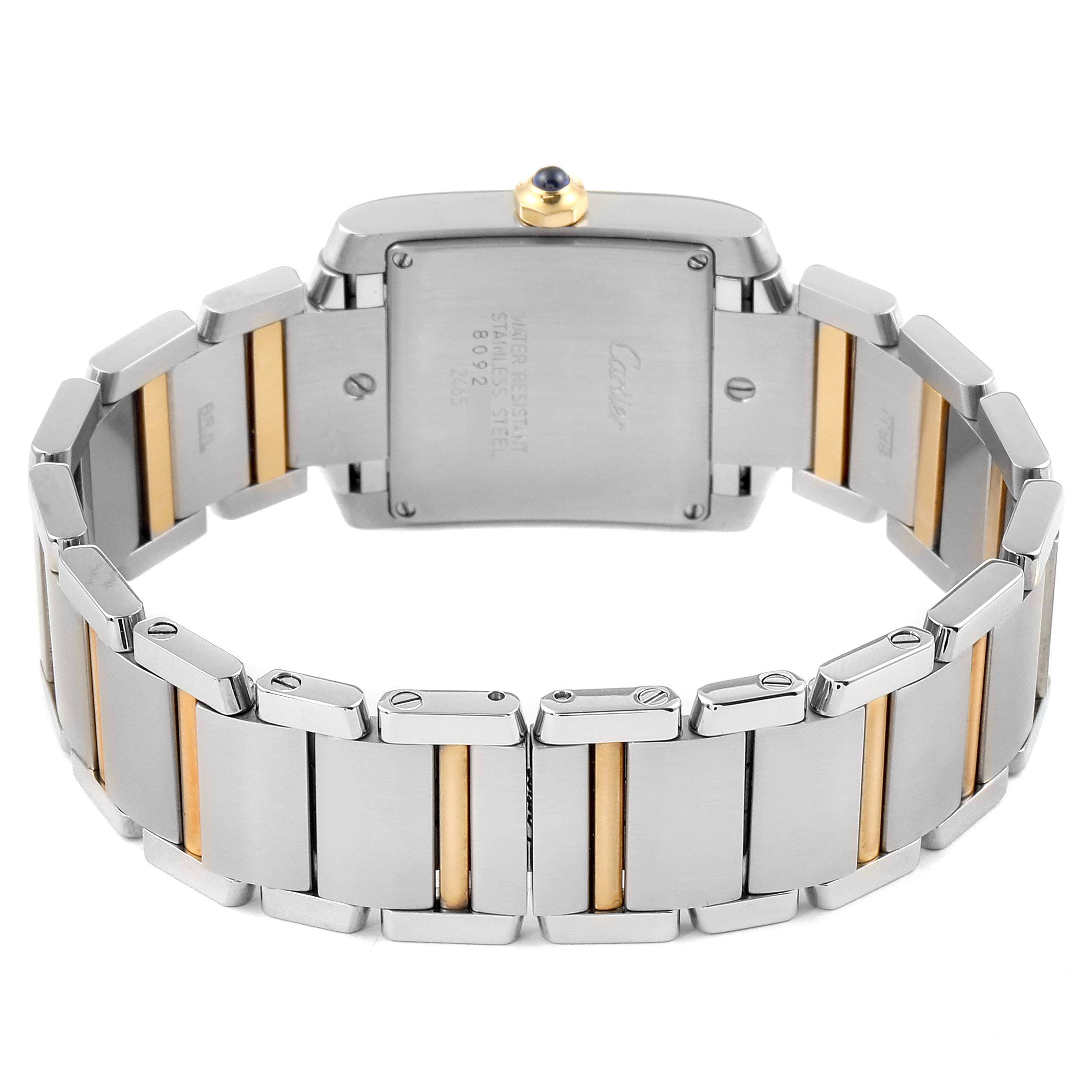The image shows the back view of a Tank Francaise Cartier watch, highlighting its stainless steel and gold bracelet and case back.