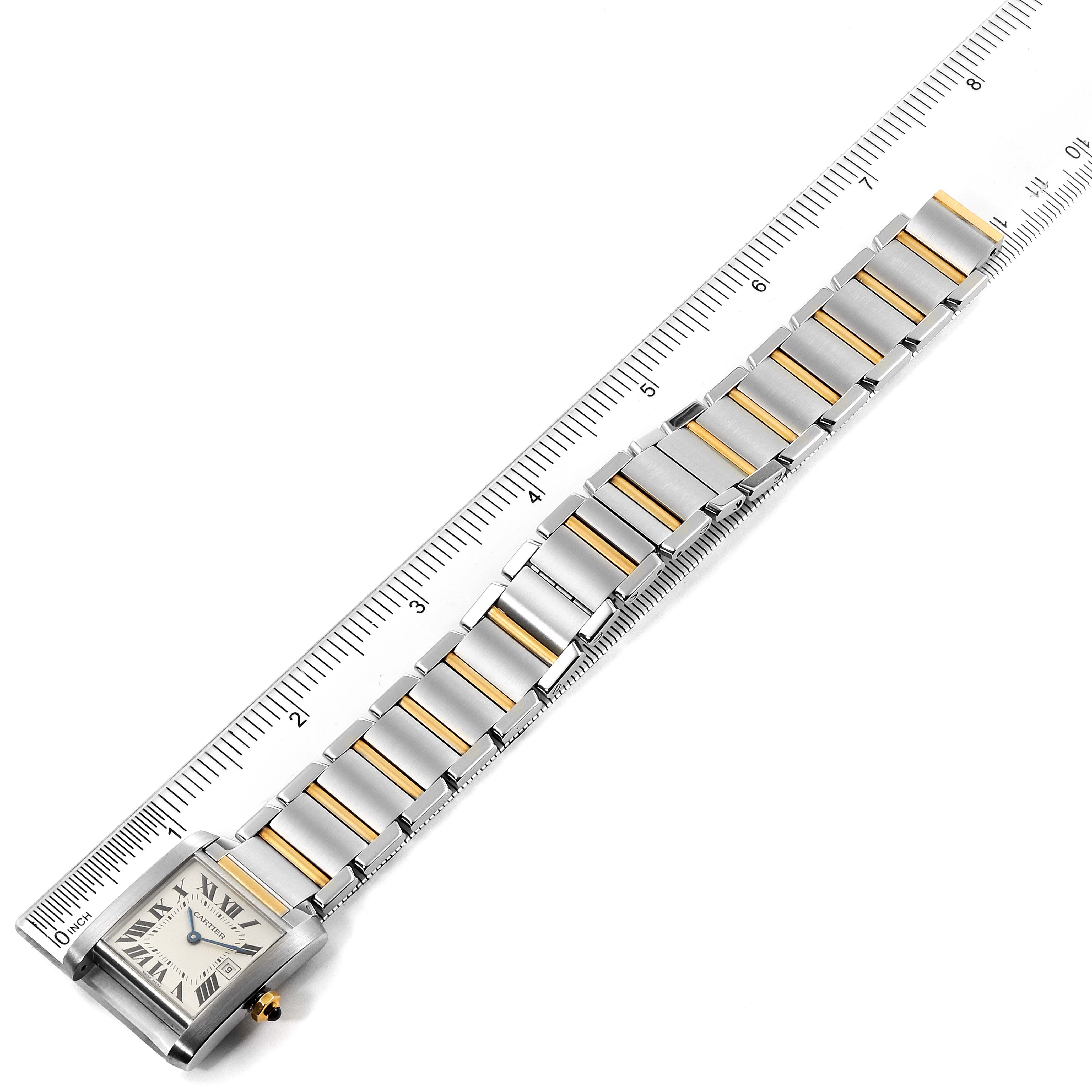 The image shows a Cartier Tank Francaise W51012Q4 Women's Steel and Gold (two tone) Silver Dial W51012Q4 Women's Steel and Gold (two tone) Silver Dial watch laid flat with a ruler measuring the length of its metal and gold bracelet.