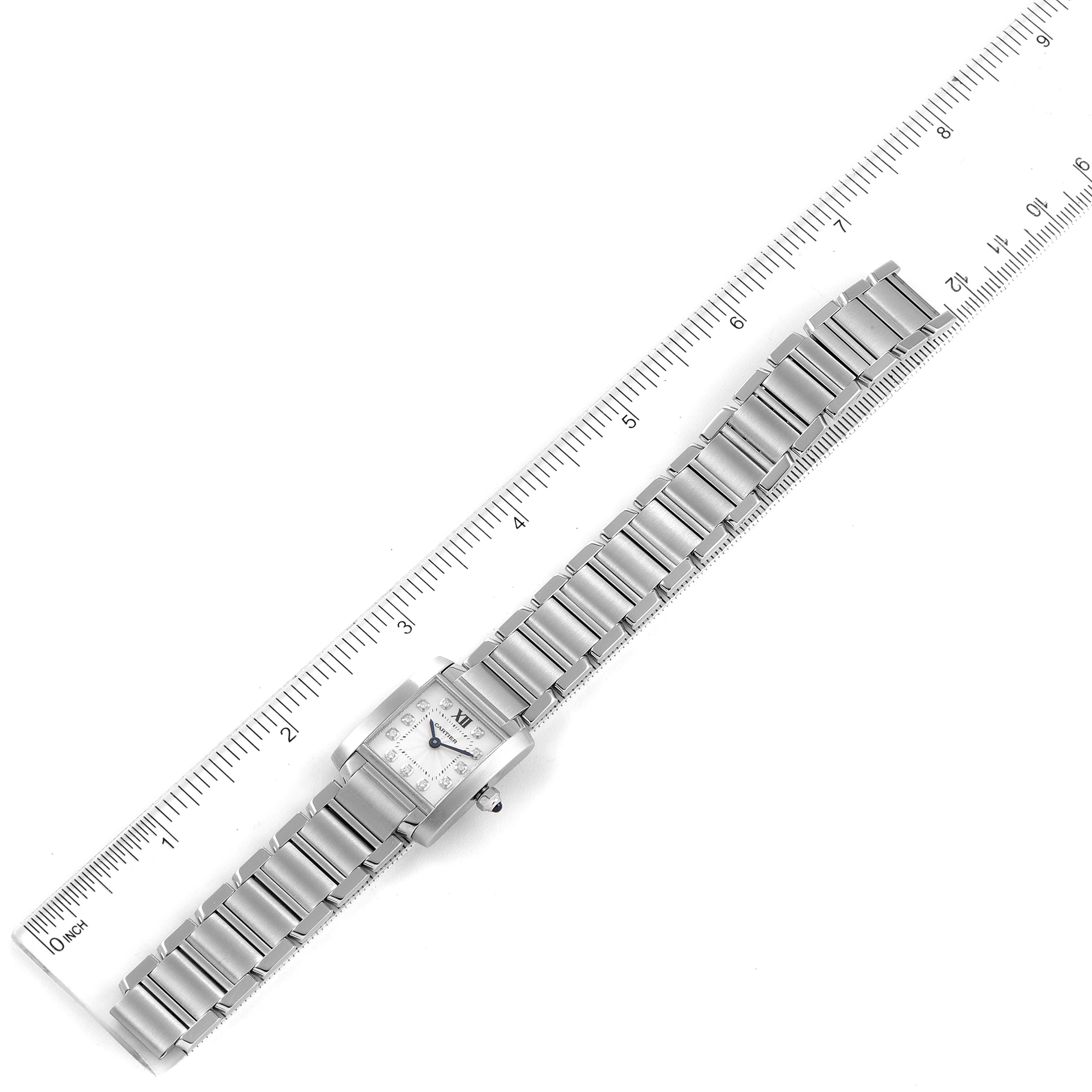The image shows a Cartier Tank Francaise WE110006 Women's Stainless Steel Silver Dial WE110006 Women's Stainless Steel Silver Dial watch laid flat next to a ruler, displaying the watch face and metal bracelet.