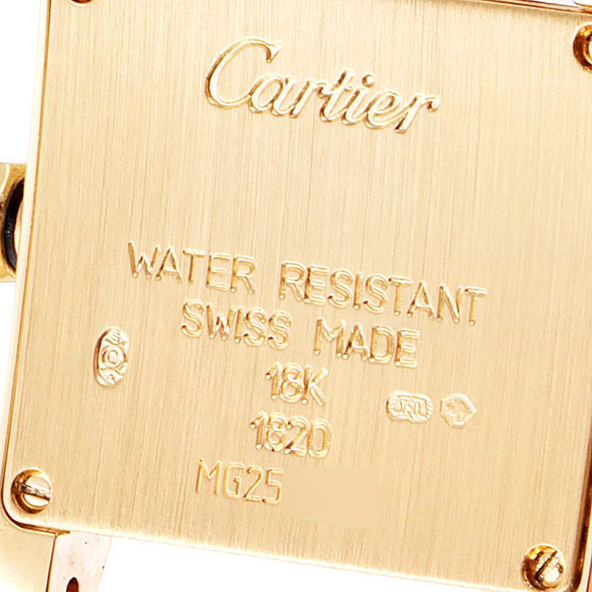 The image shows the back case of a Cartier Tank Francaise W50002N2 Women's Yellow Gold Silver Dial W50002N2 Women's Yellow Gold Silver Dial watch, highlighting the engraved details and screws.