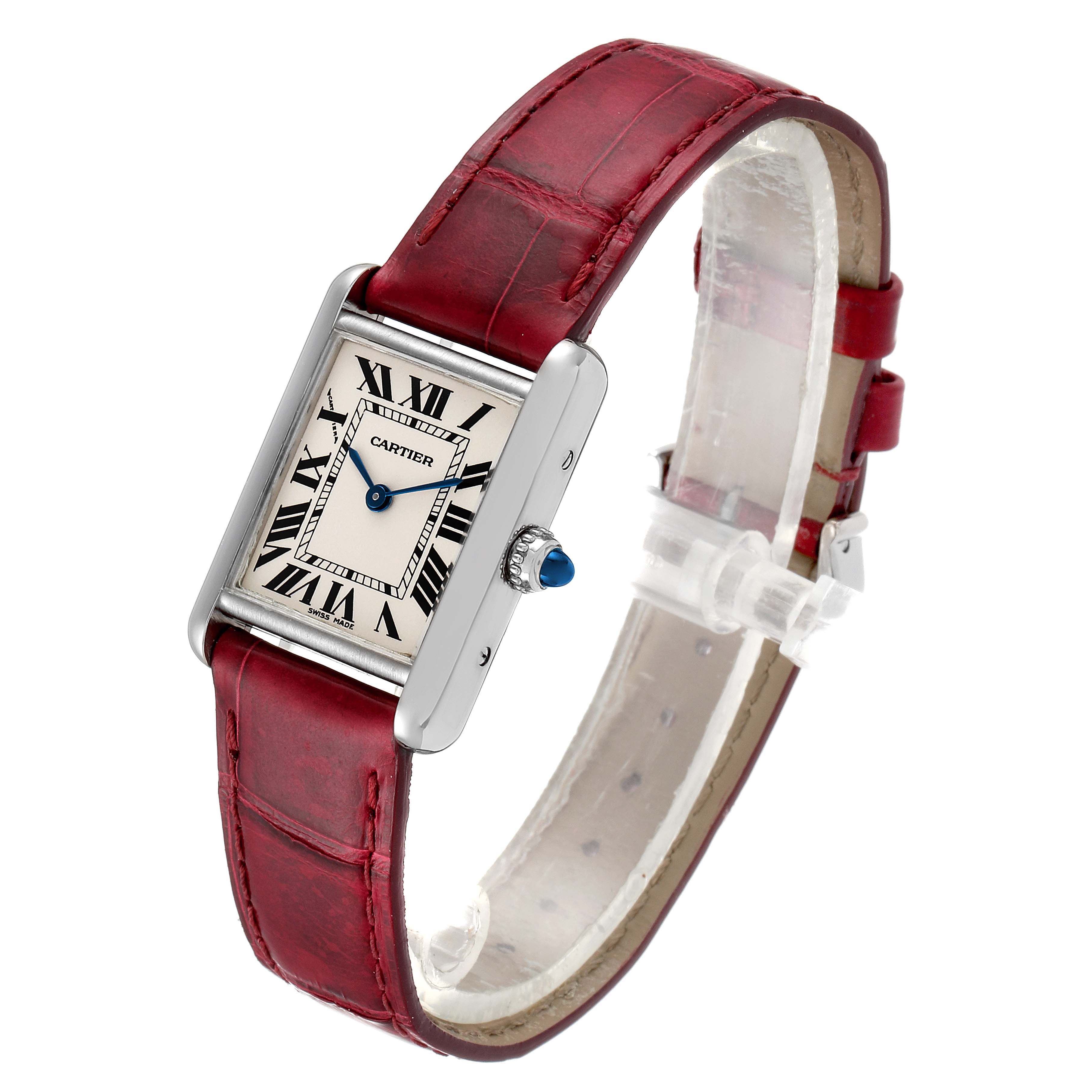 This image shows a Tank Louis model by Cartier from a slightly angled front view, featuring its red leather strap, white dial, and Roman numerals.