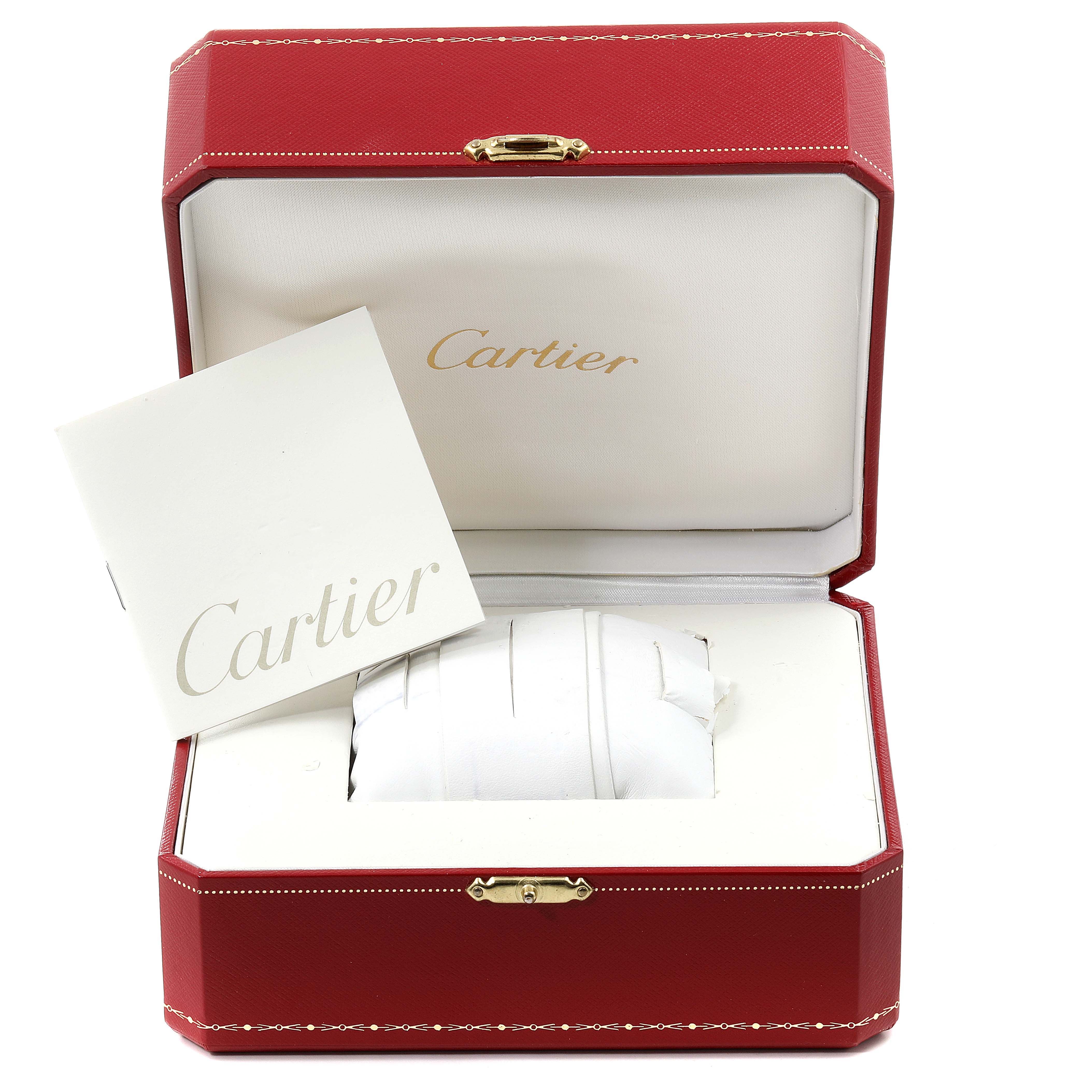 The image shows an open Cartier watch box with a cushion and booklet for the Tank Louis model.