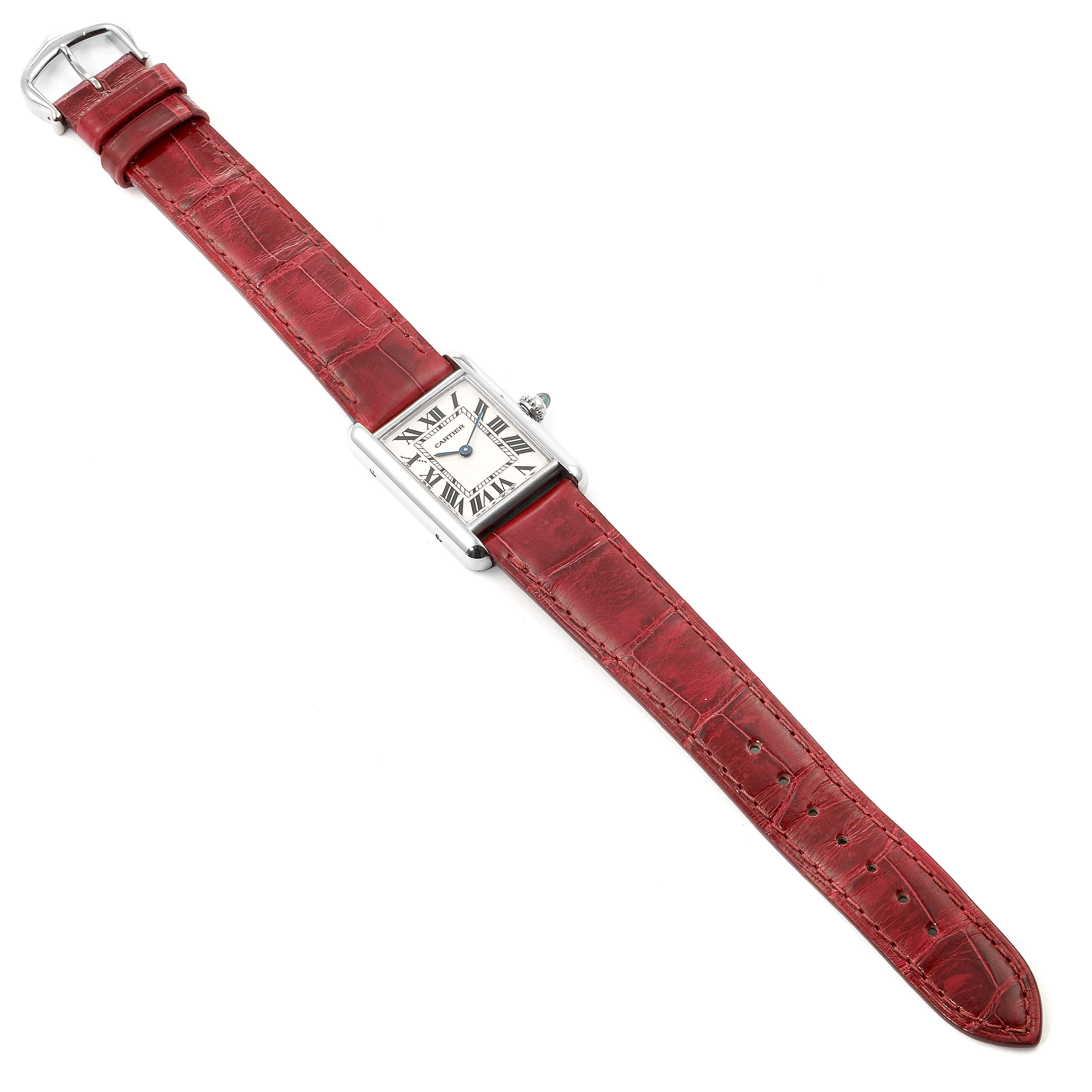 The image shows a Tank Louis model watch by Cartier, laid flat with a red leather strap and rectangular case.