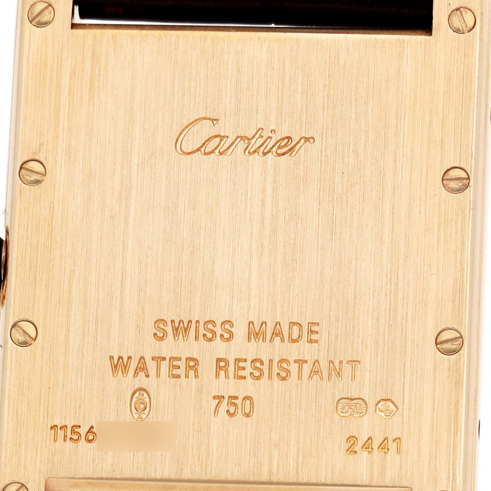 The image shows the back of a Cartier Tank Louis W1529756 Men's Yellow Gold Silver Dial watch with engravings indicating its Swiss origin and water resistance.