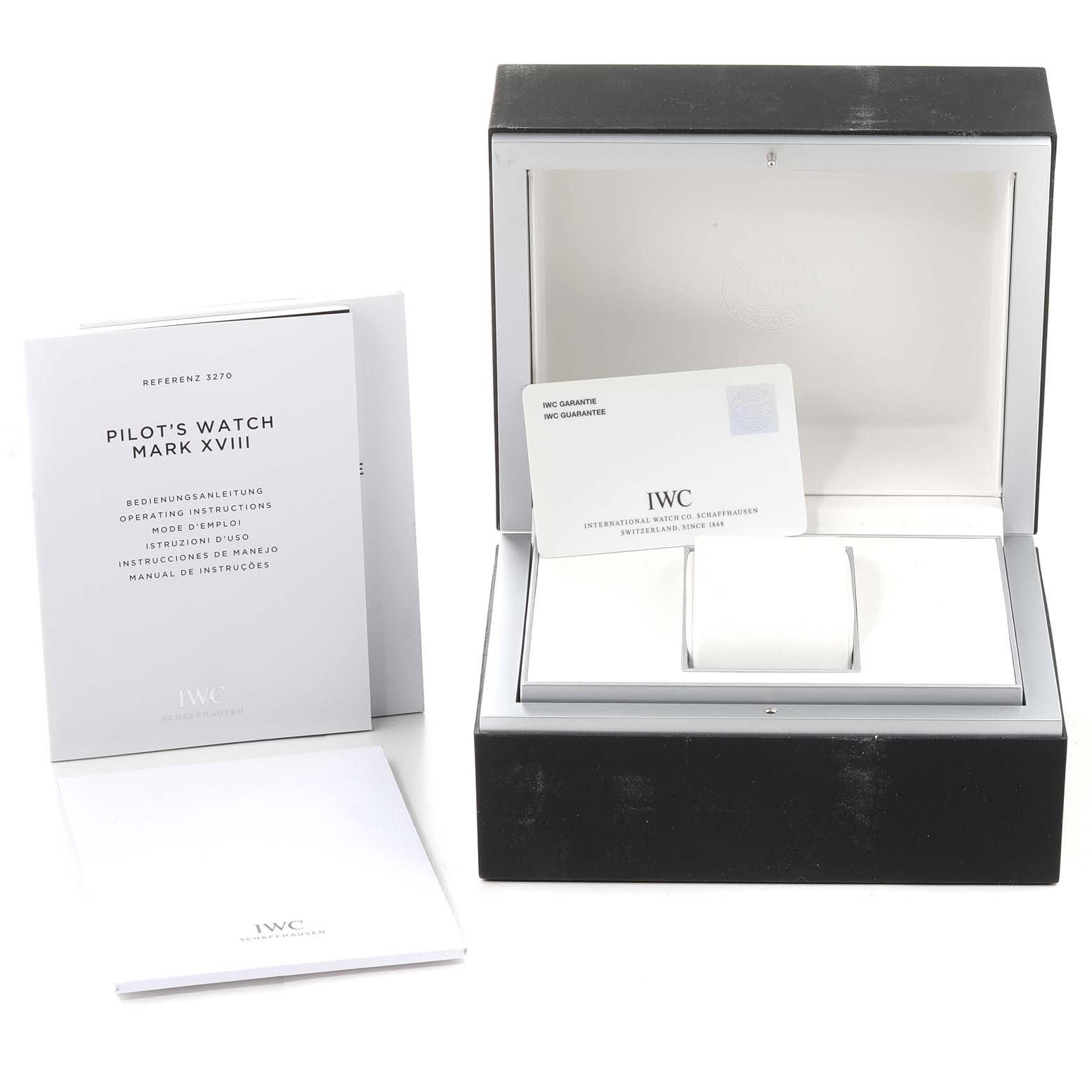 The image shows the packaging, instructional booklet, and guarantee card for an IWC Pilot IW327007 Men's Stainless Steel Black Dial IW327007 Men's Stainless Steel Black Dial's Watch Mark XVIII.
