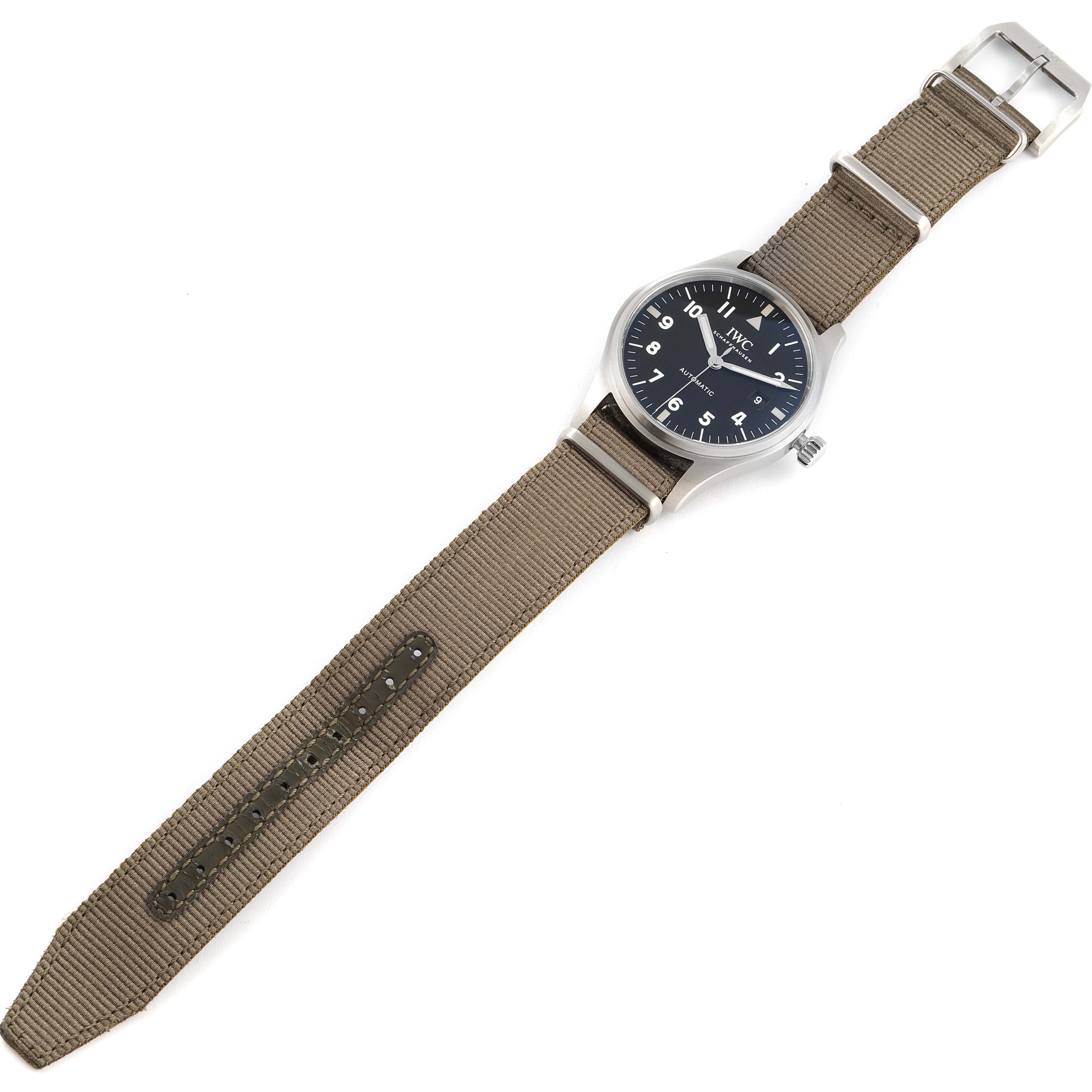 The image shows the entire IWC Pilot IW327007 Men's Stainless Steel Black Dial IW327007 Men's Stainless Steel Black Dial model watch, including its face, crown, and strap, from a top-down angle.