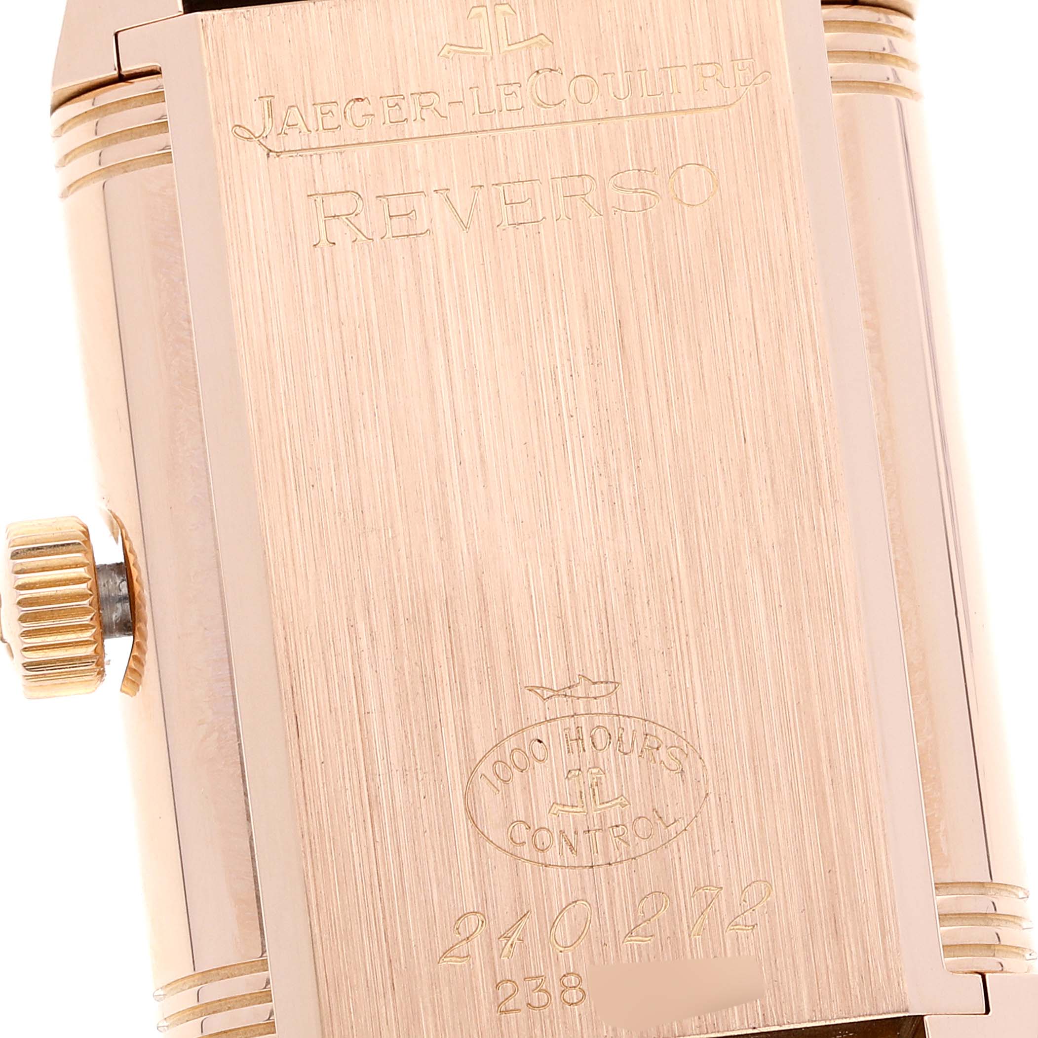 This is a close-up of the back of a Jaeger-LeCoultre Reverso model watch, showing the crown and engravings.