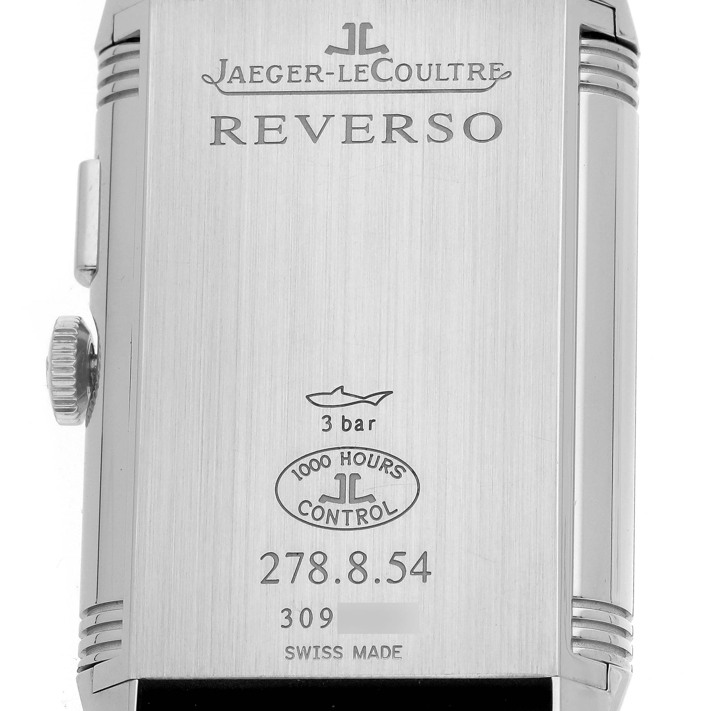 The image shows the back of a Jaeger-LeCoultre Reverso watch, displaying its engravings and side crown.
