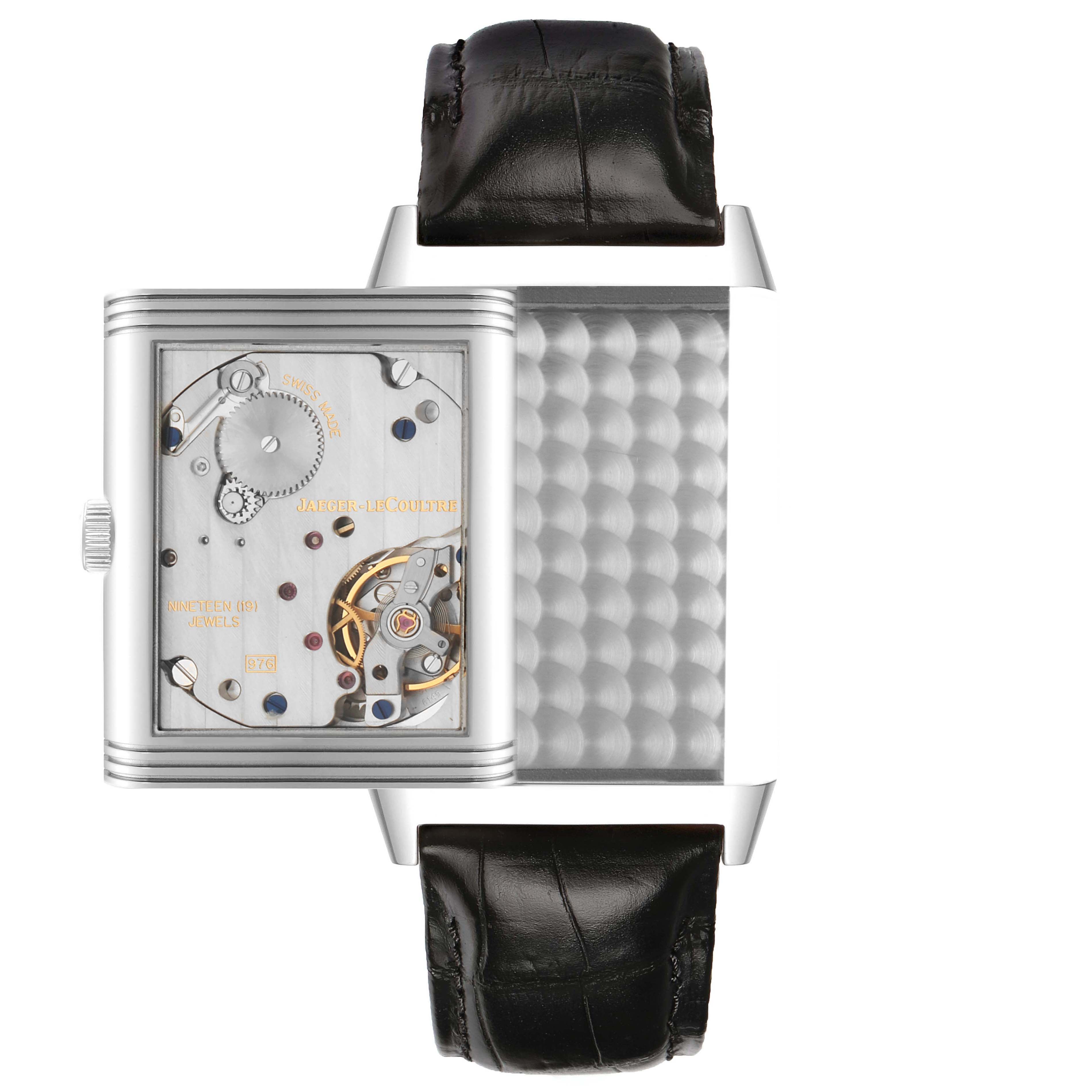 The Jaeger-LeCoultre Reverso watch is shown at a top view, displaying its mechanism and swivel case.