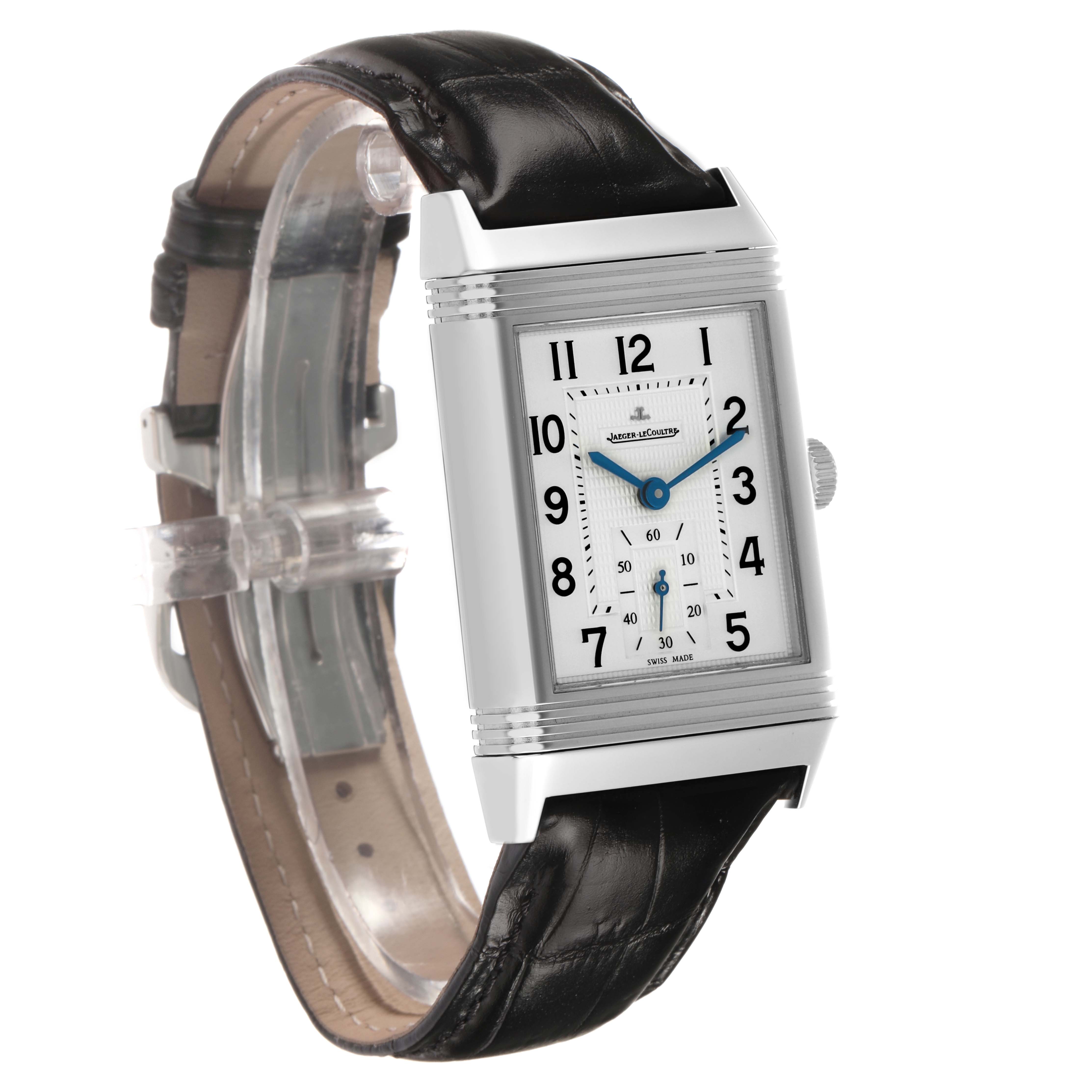 The Jaeger-LeCoultre Reverso watch is shown at an angled side view, displaying the rectangular case, dial, and leather strap.