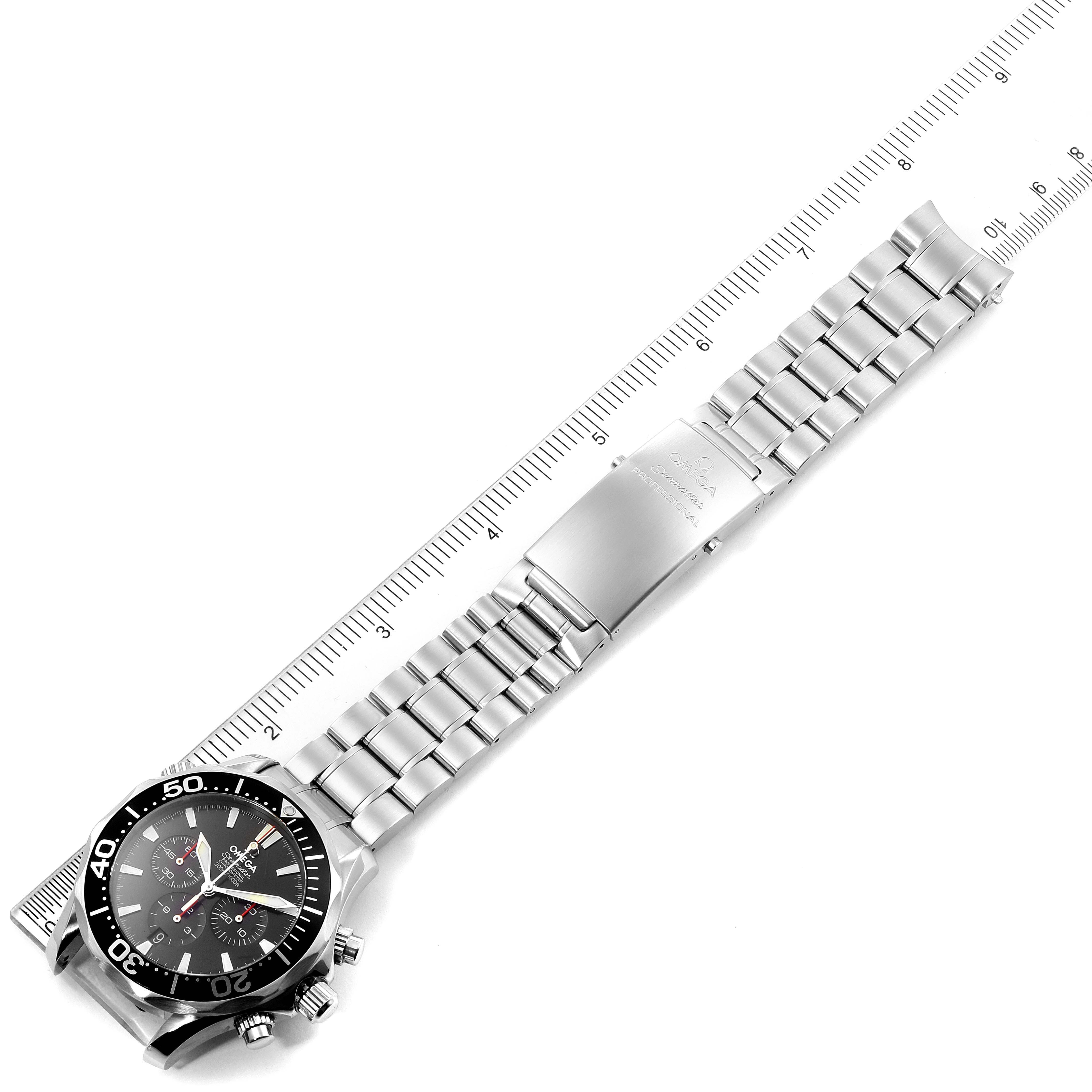 The image shows the Omega Seamaster 2594.50.00 Men's Stainless Steel Black Dial 2594.50.00 Men's Stainless Steel Black Dial watch laid flat, highlighting its metal strap, clasp, and dial, positioned alongside a scale ruler.