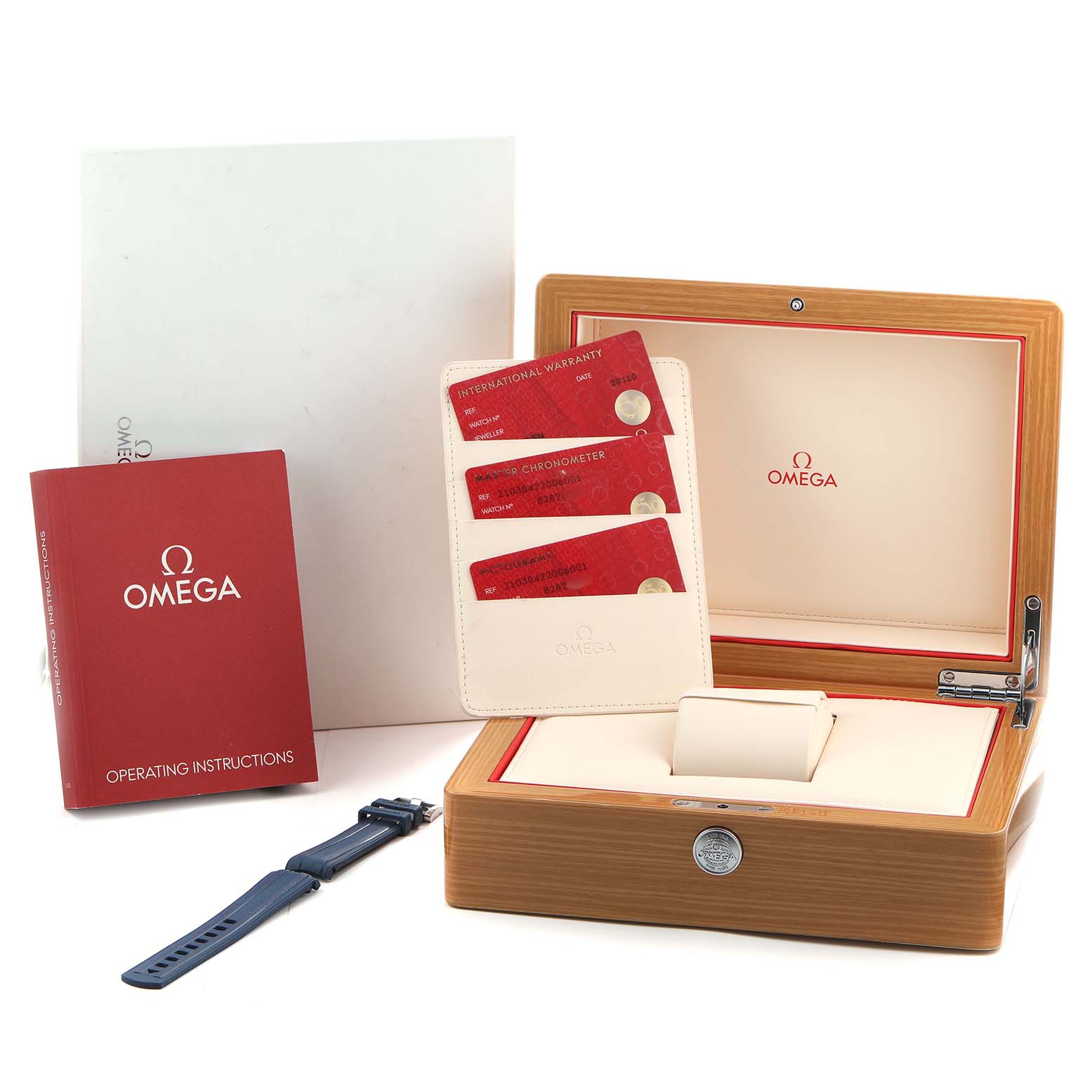 The image shows an Omega Seamaster 210.30.42.20.06.001 Men's Stainless Steel Grey Dial watch box, instruction book, warranty cards, and a strap from a side angle.