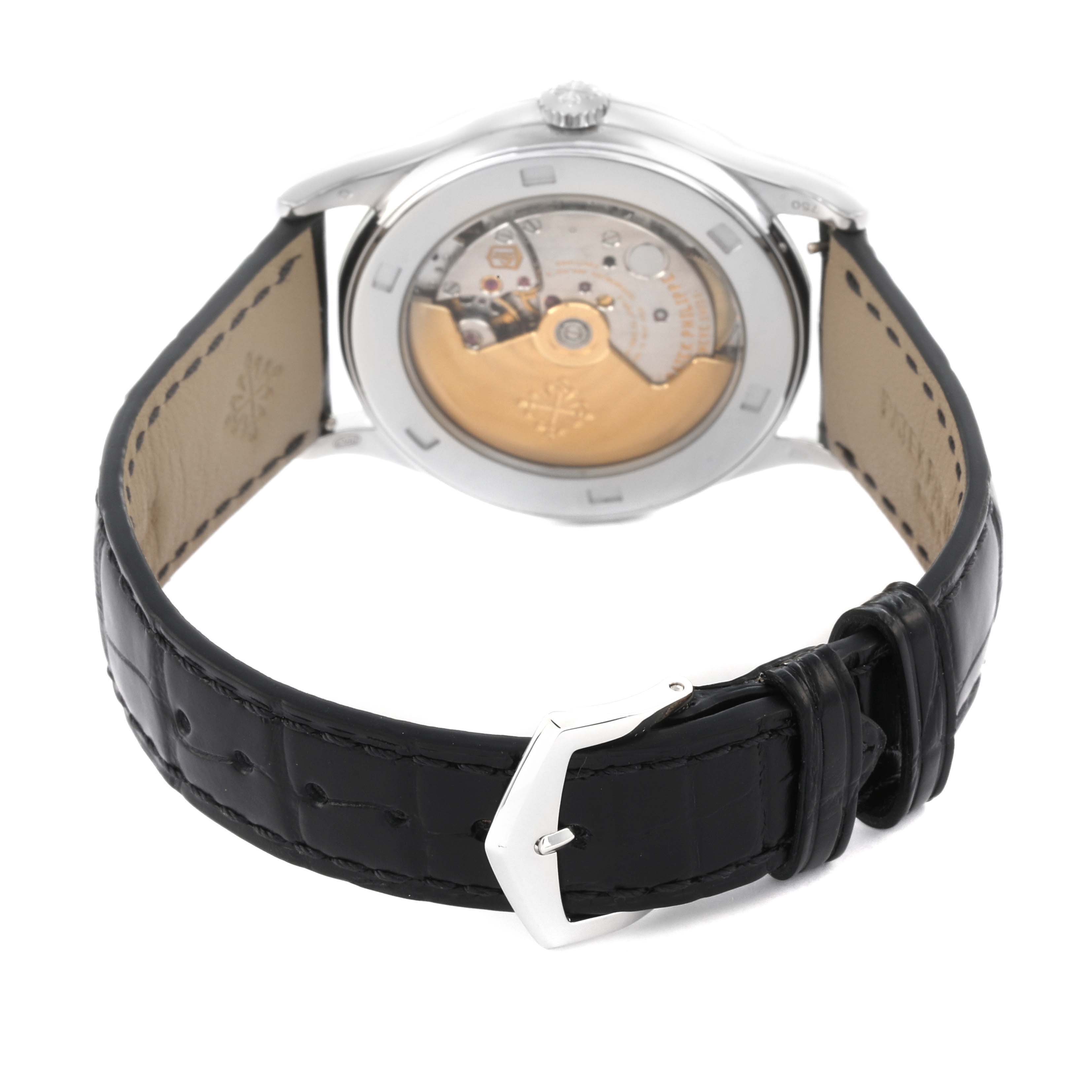 The Patek Philippe Calatrava 5297G-001 Men's White Gold Black Dial 5297G-001 Men's White Gold Black Dial is shown from the back, displaying the movement and a black leather strap with a buckle.