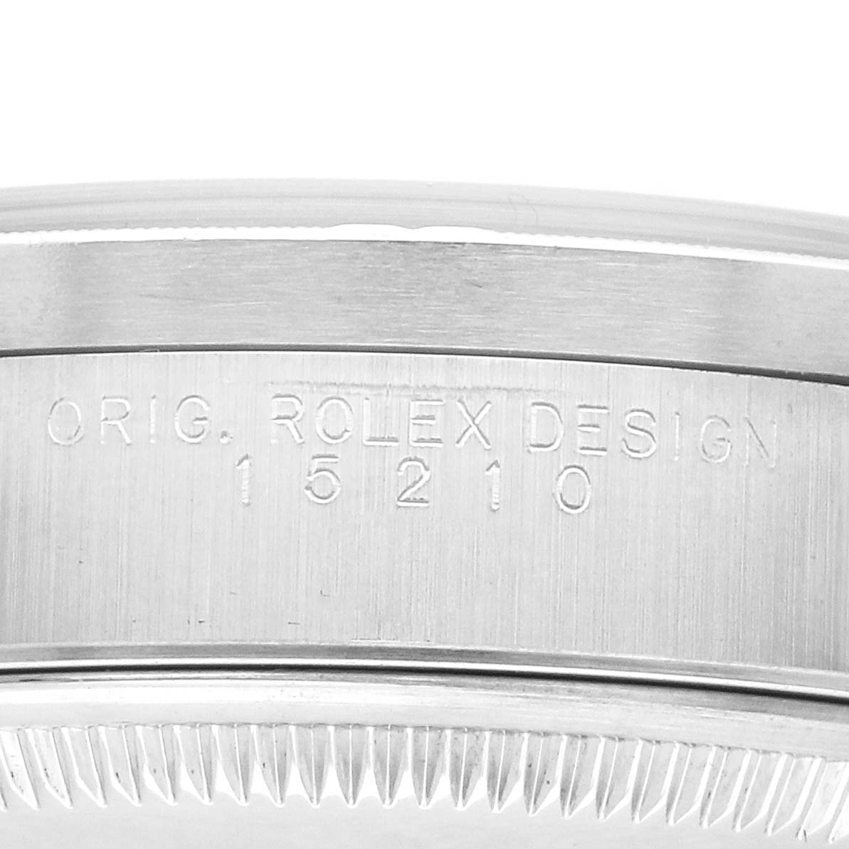 The image shows the engraved side view of the case of a Rolex Date 15210 Men's Stainless Steel Blue Dial model, highlighting the design and model number.