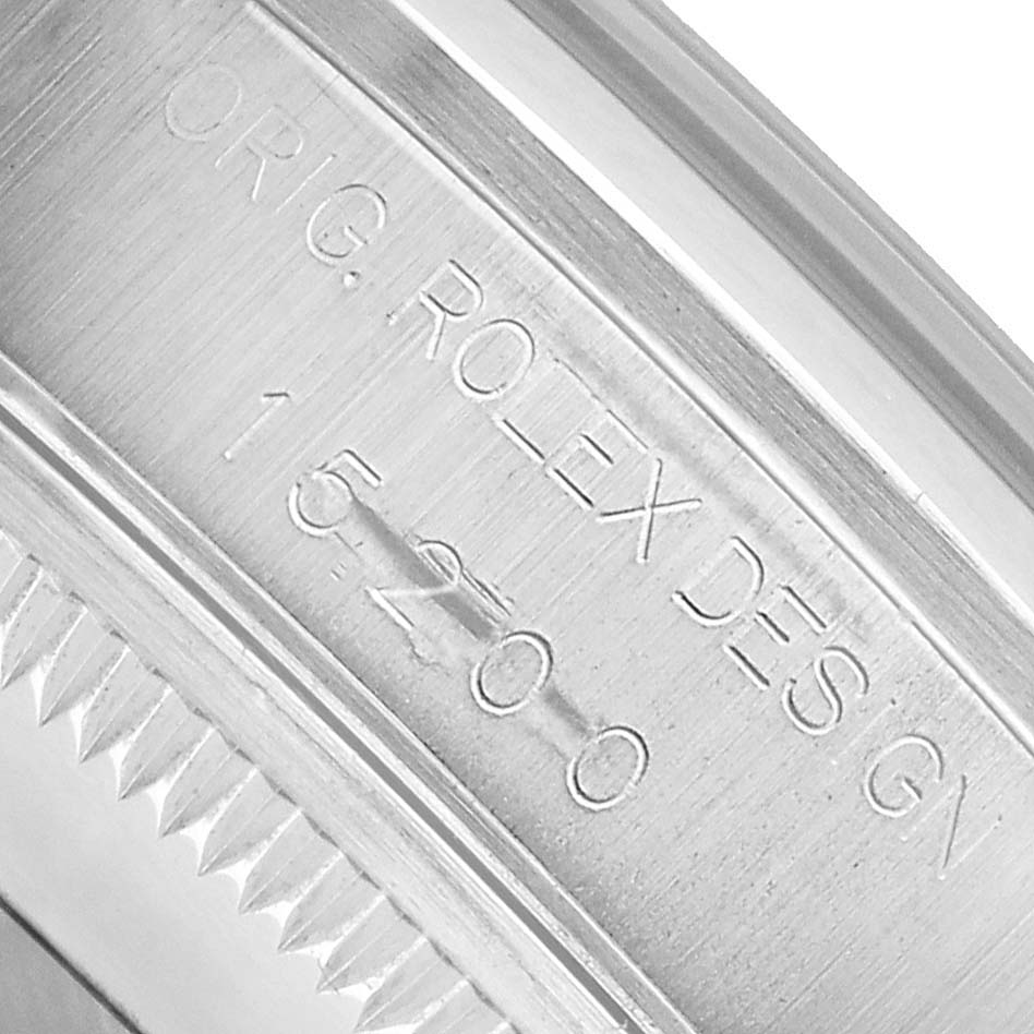 The image shows a close-up of the case engraving on a Rolex Date 15200 Men's Stainless Steel Blue Dial model, reading "ORIG. ROLEX DESIGN 15200."