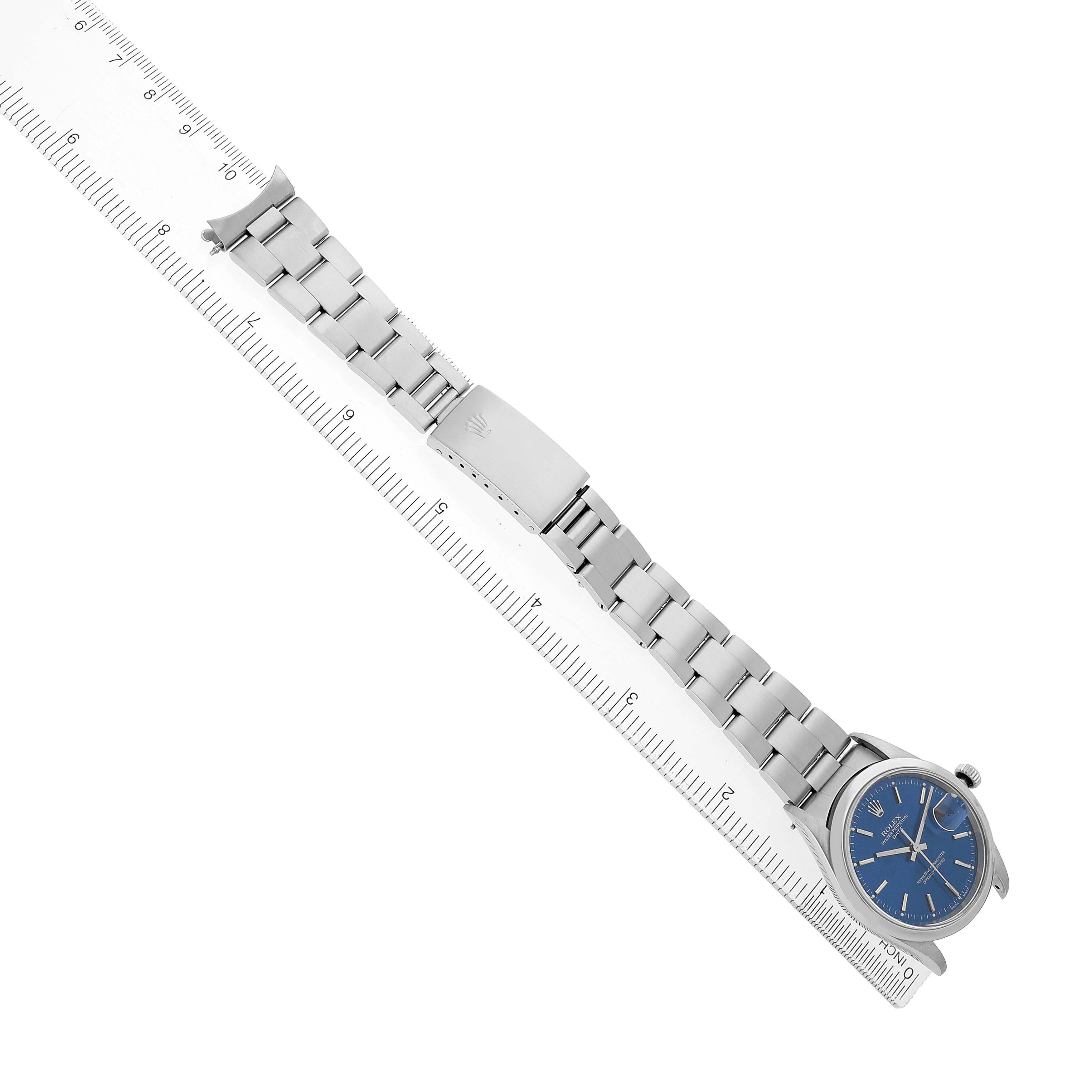 The Rolex Date 15200 Men's Stainless Steel Blue Dial watch is shown at an angled top-down view, displaying the bracelet, clasp, and blue dial.