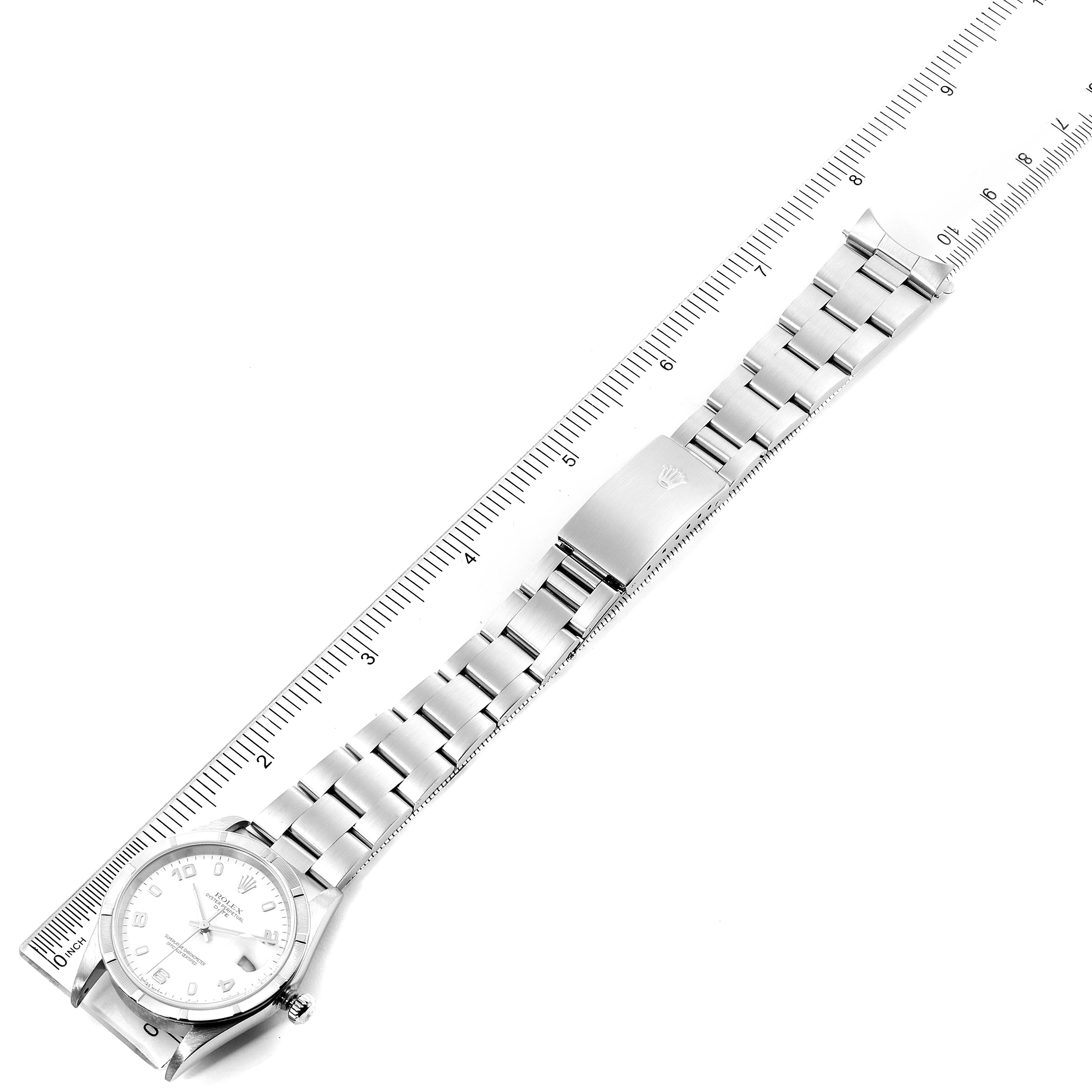The image shows a Rolex Date 15210 Men's Stainless Steel White Dial 15210 Men's Stainless Steel White Dial model watch laid flat with its stainless steel bracelet extended against a ruler.