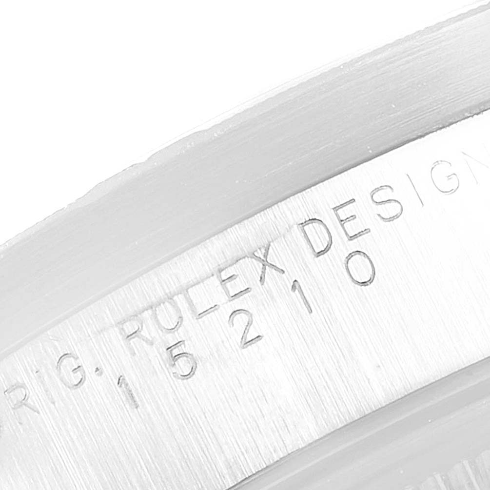 This close-up image shows the engraved serial number on the case of a Rolex Date 15210 Men's Stainless Steel White Dial 15210 Men's Stainless Steel White Dial model watch.