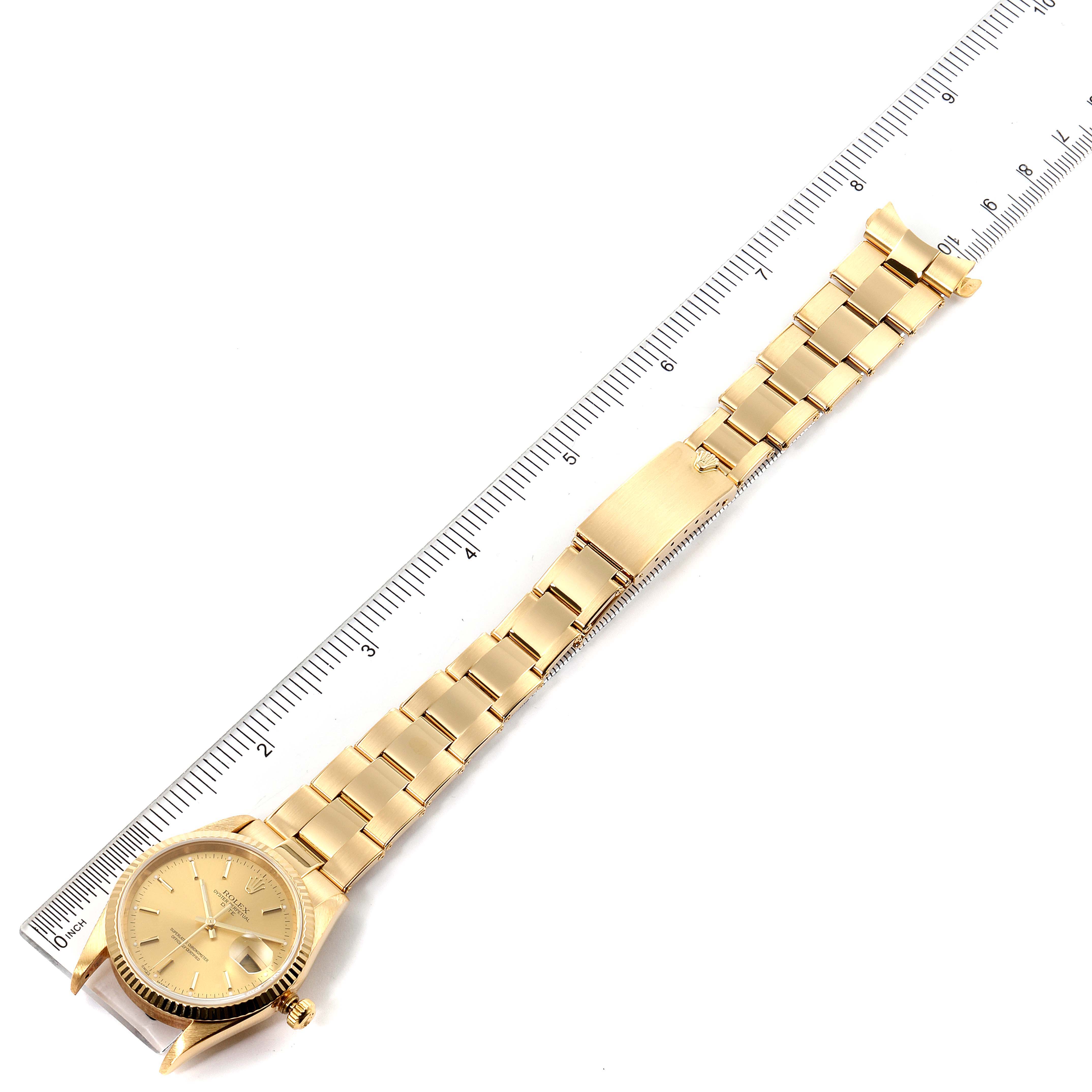 The Rolex President 15238 Men
s Yellow Gold Champagne Dial 15238 Men
s Yellow Gold Champagne Dial model watch is displayed at a top-down angle, showing the face, band, and clasp extended next to a ruler.