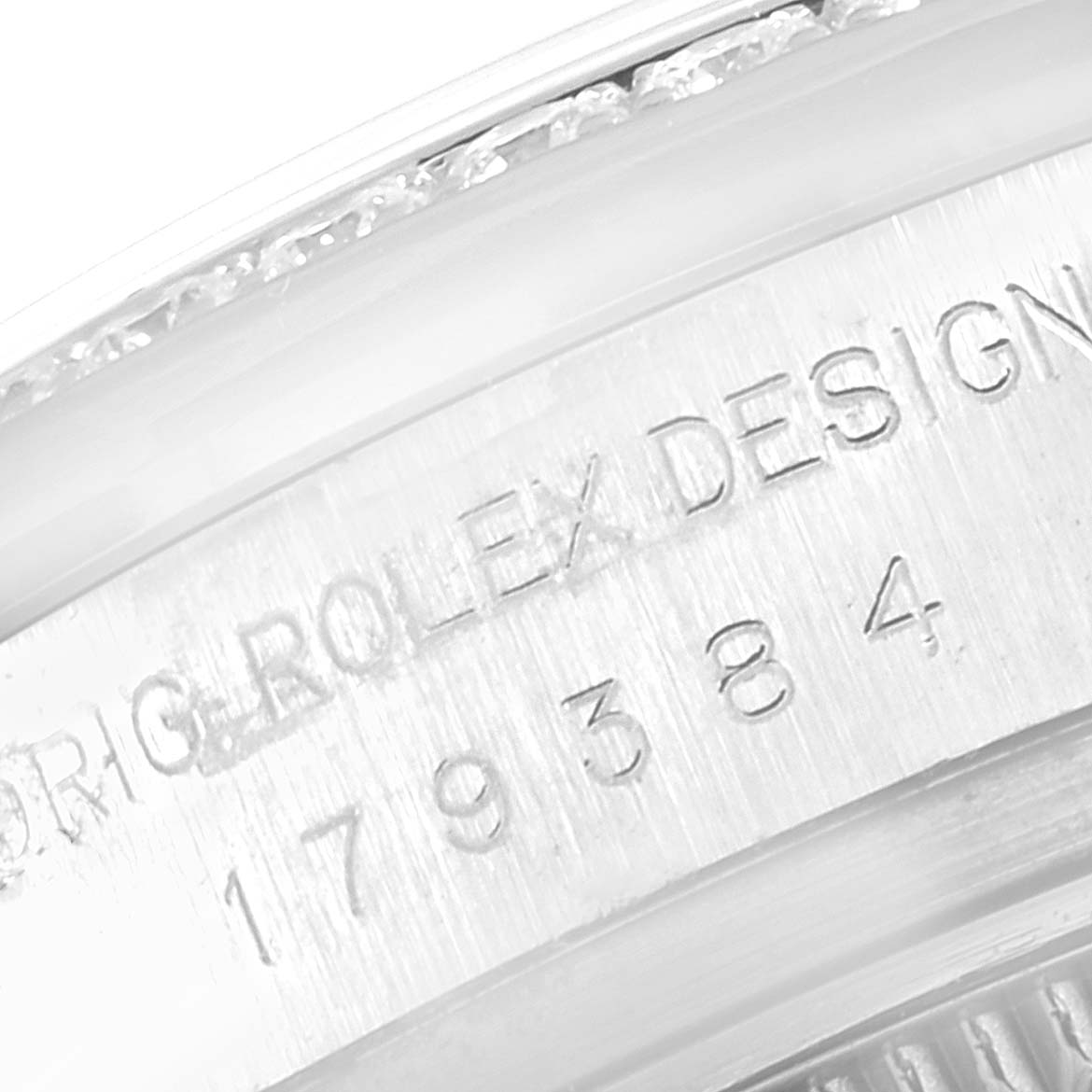 The image shows a close-up of the Rolex Datejust 179384 Women's Stainless Steel Black Dial 179384 Women's Stainless Steel Black Dial model's engraved inner bezel with serial numbers.