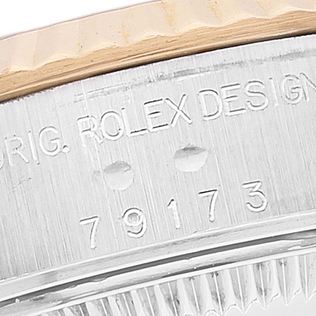 This image shows a close-up of the serial number and part of the bezel of a Rolex Datejust 79173 Women's Steel and Gold (two tone) White Dial 79173 Women's Steel and Gold (two tone) White Dial model watch.