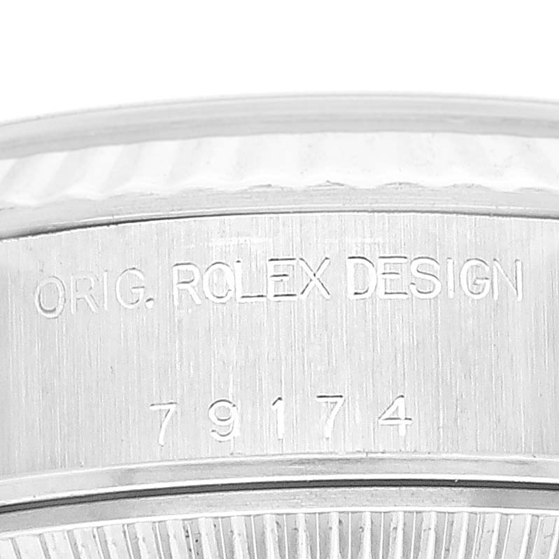 This image shows a close-up of the case side of a Rolex Datejust 79174 Women's Stainless Steel Silver Dial 79174 Women's Stainless Steel Silver Dial, displaying the inscriptions "ORIG. ROLEX DESIGN 79174."
