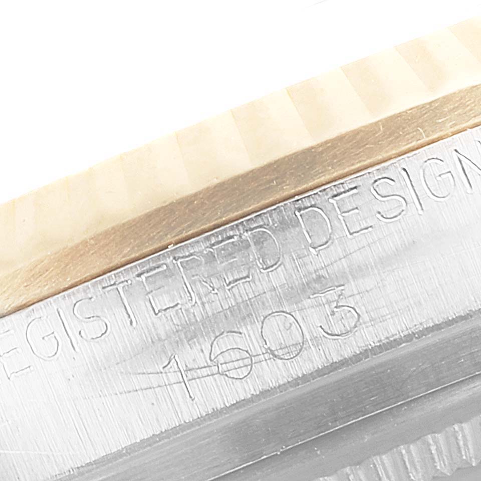 The image shows a close-up angle of the bezel and engraved serial number on a Vintage Collection model by Rolex.