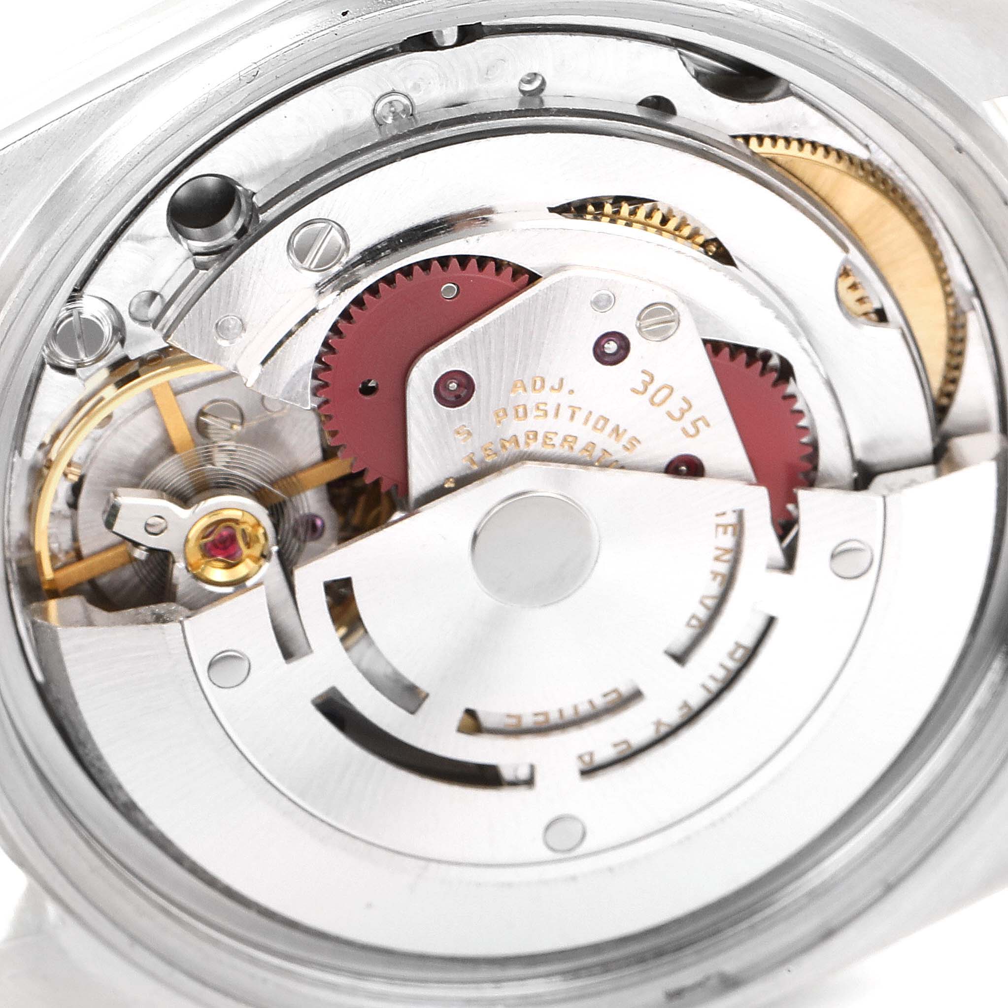 This is a close-up of the inner mechanical movement of the Vintage Collection model by Rolex, showing gears, rotors, and engravings.
