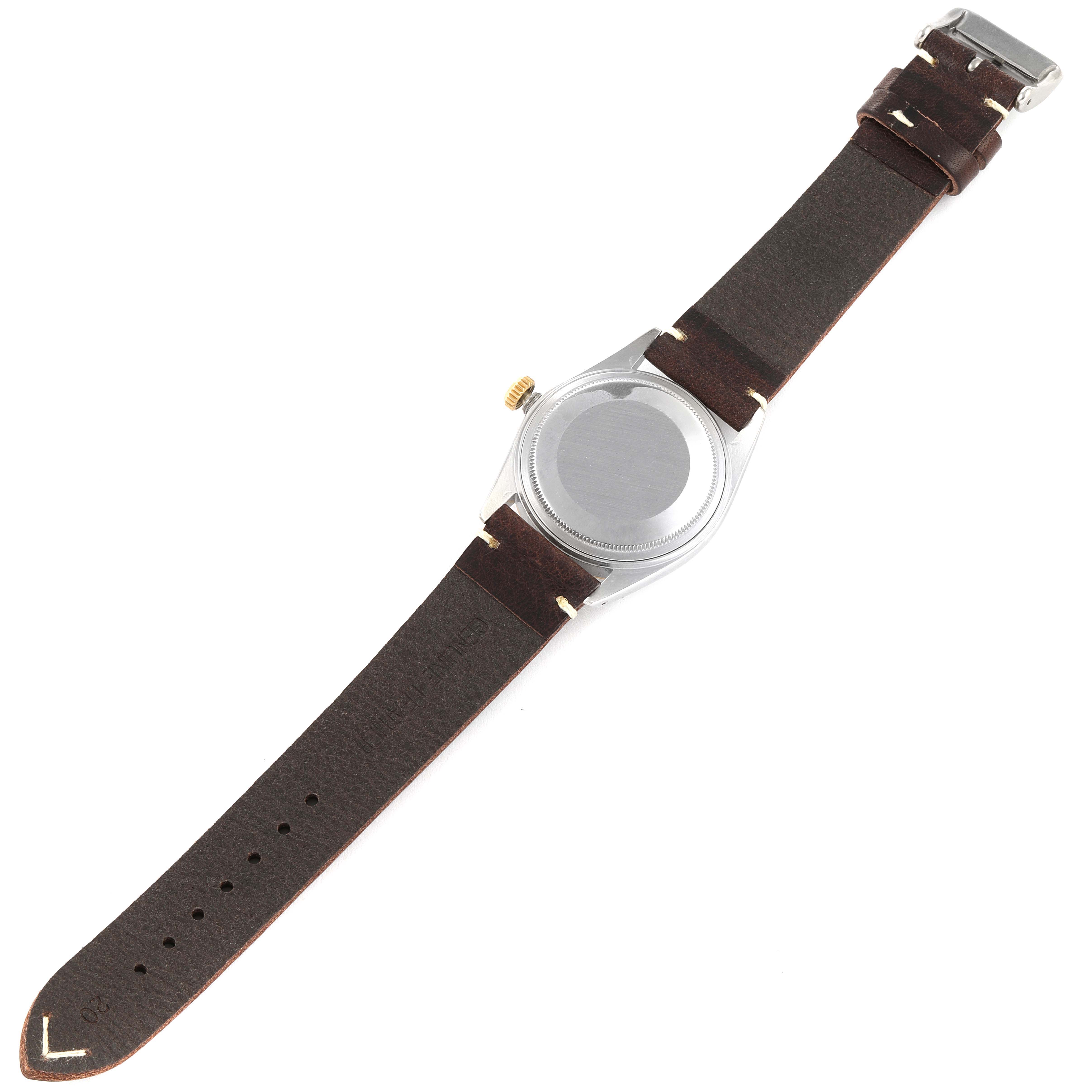 The Vintage Collection Rolex watch is shown from the back, displaying its case and brown leather strap.