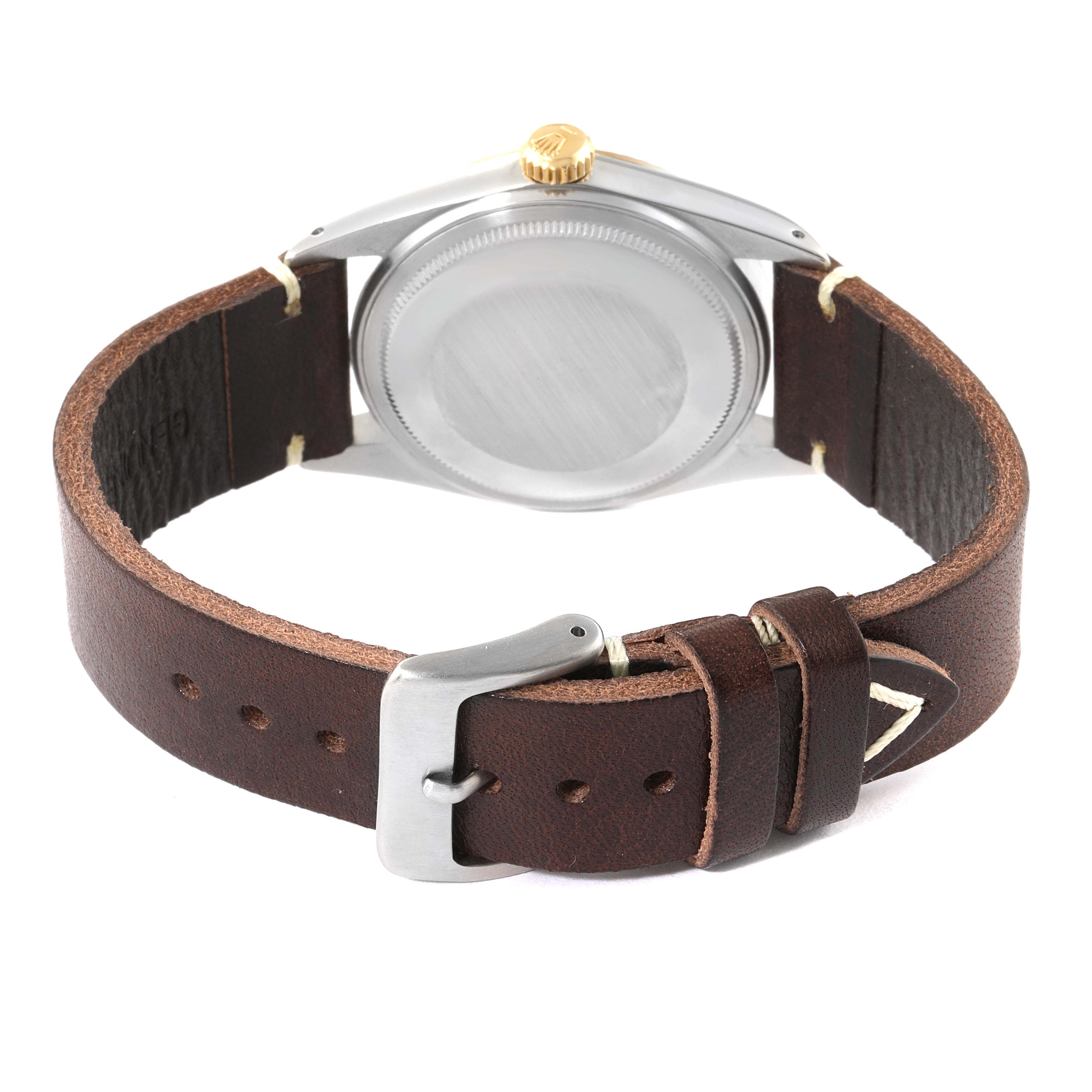 This image shows the back of the Rolex Vintage Collection 16013 Men's Steel and Gold (two tone) Champagne Dial 16013 Men's Steel and Gold (two tone) Champagne Dial watch with a leather strap and a stainless steel buckle.