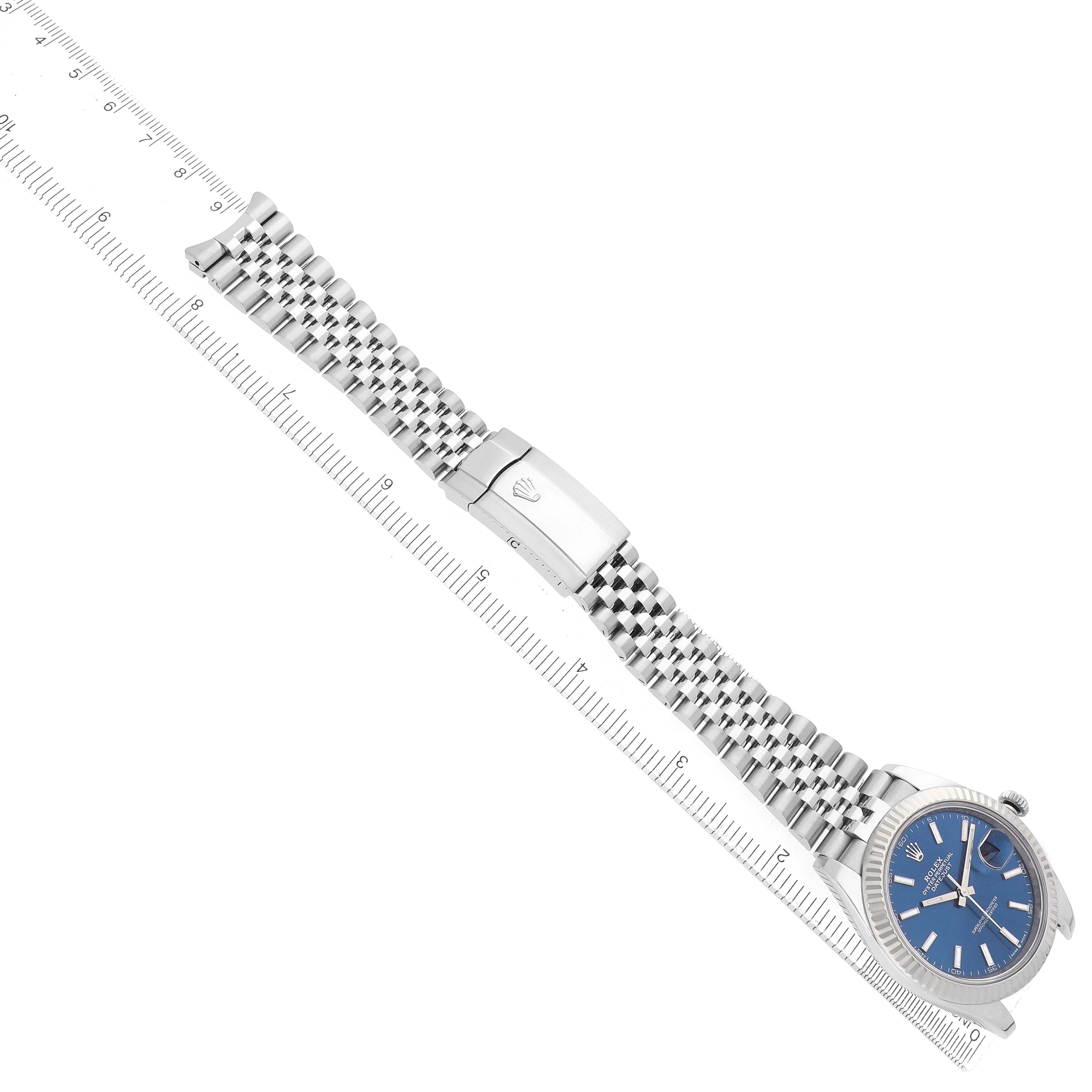 The Rolex Datejust 41 126334 Men's Stainless Steel Blue Dial is shown from a top view, displaying the watch face, bracelet, and clasp alongside a ruler for scale.