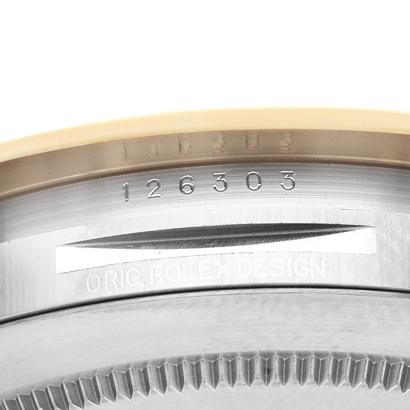 The image shows a close-up of the Rolex Datejust 41 126303 Men
s Steel and Gold (two tone) Black Dial 126303 Men
s Steel and Gold (two tone) Black Dial
s case back with serial numbers and “ORIG. ROLEX DESIGN” inscription.