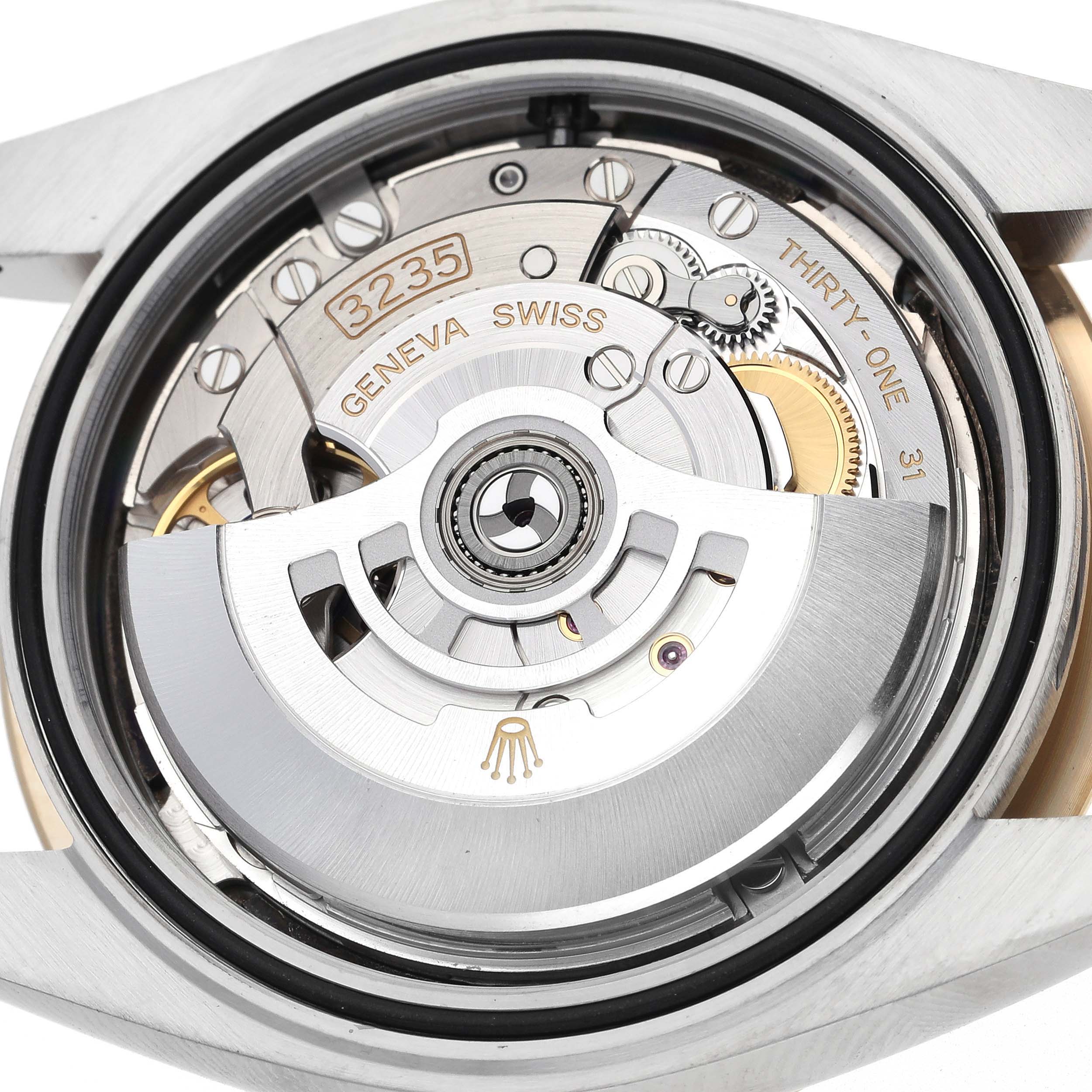 The image shows the movement of a Rolex Datejust 41 126303 Men
s Steel and Gold (two tone) Black Dial 126303 Men
s Steel and Gold (two tone) Black Dial, highlighting the rotor and intricate internal mechanics.