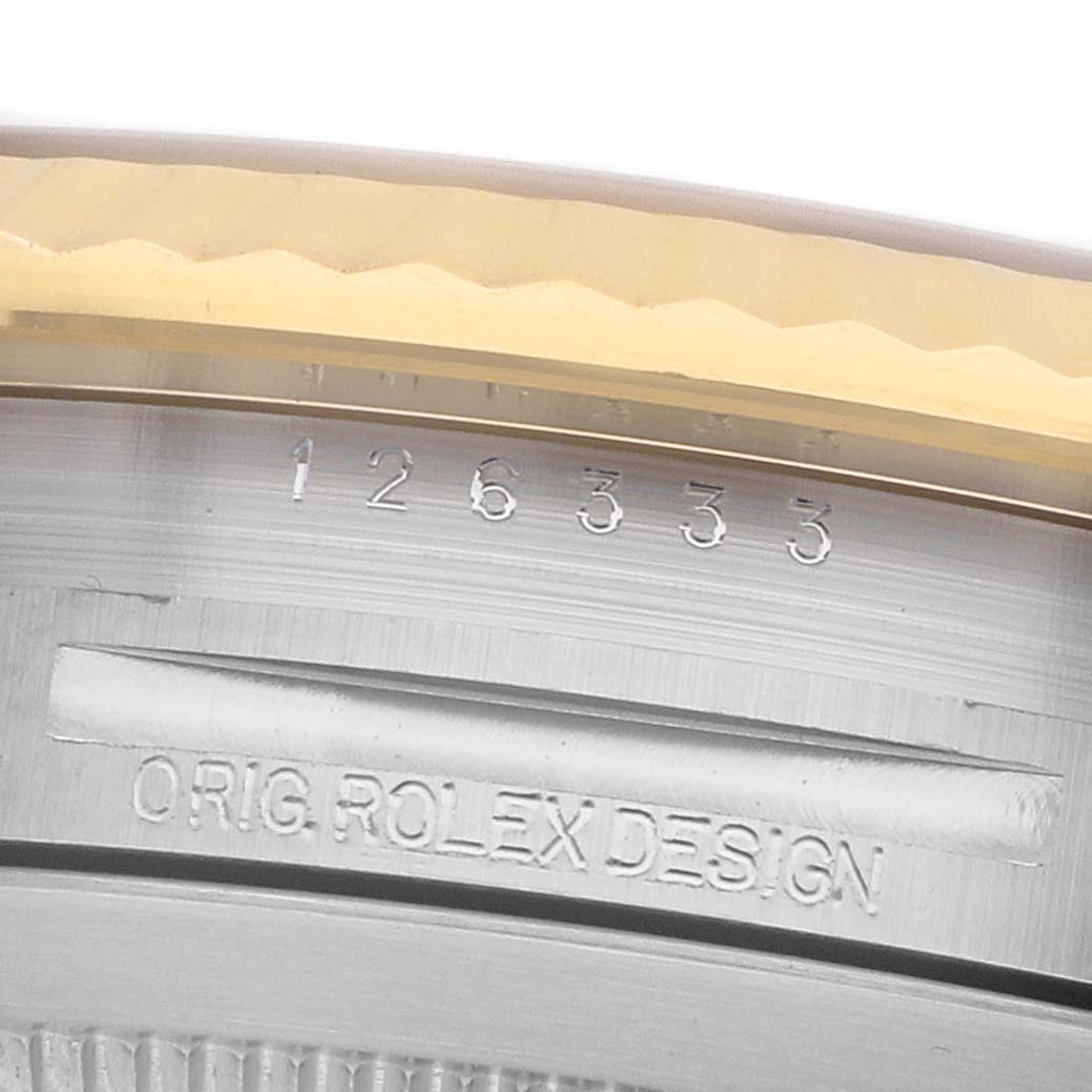 The image shows a close-up of a Rolex Datejust 41 126333 Men's Steel and Gold (two tone) Grey Dial model's case side, highlighting engraved model and design markings.