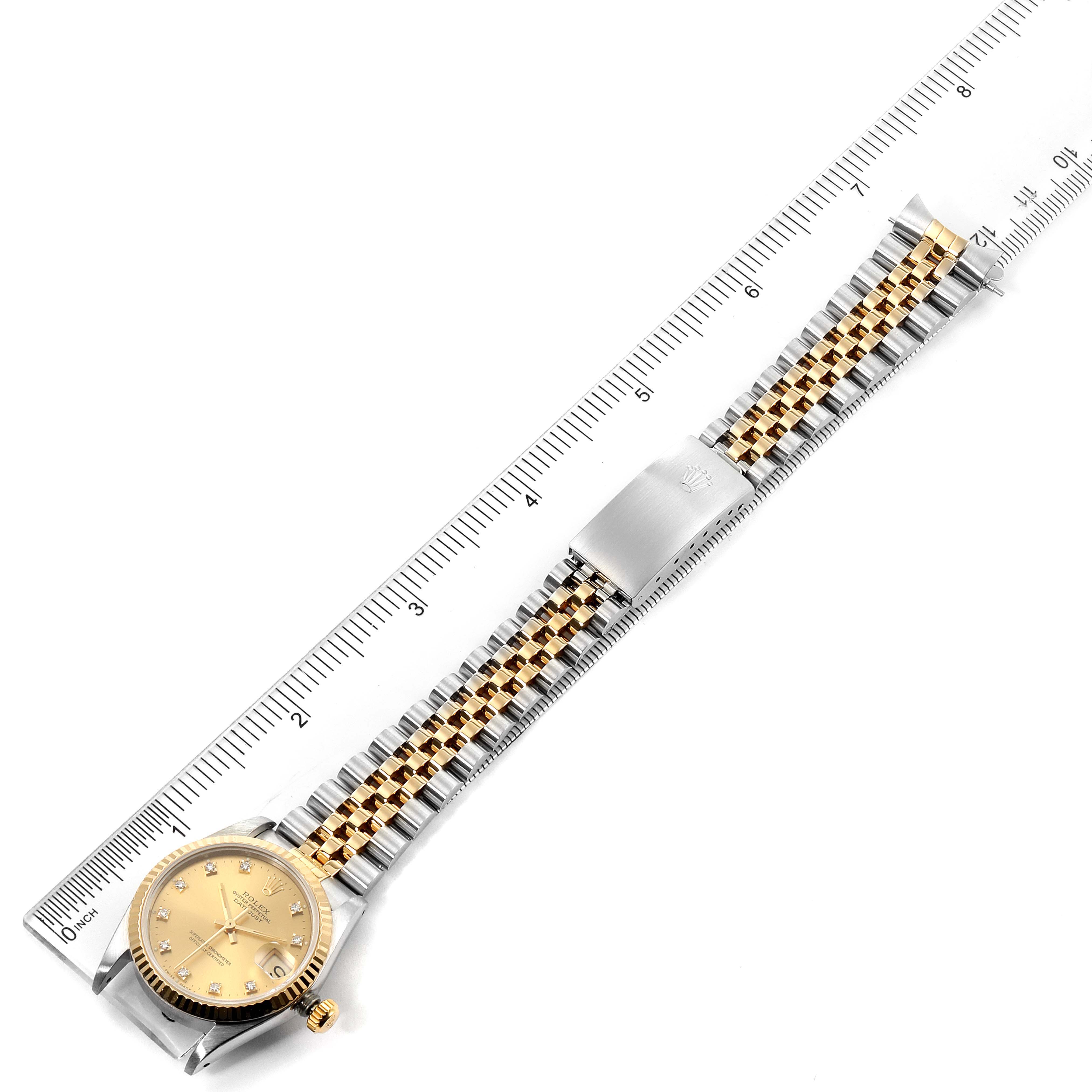 The image shows a top-down view of a Rolex Mid-Size 68273 Women's Steel and Gold (two tone) Champagne Dial 68273 Women's Steel and Gold (two tone) Champagne Dial model watch, including the face, bezel, and full bracelet laid out beside a measuring ruler.