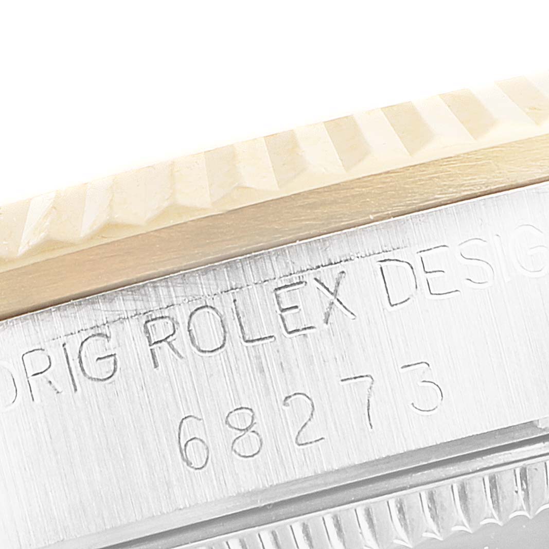 This image shows a close-up of the casing and engraved serial number of a Mid-Size Rolex watch.