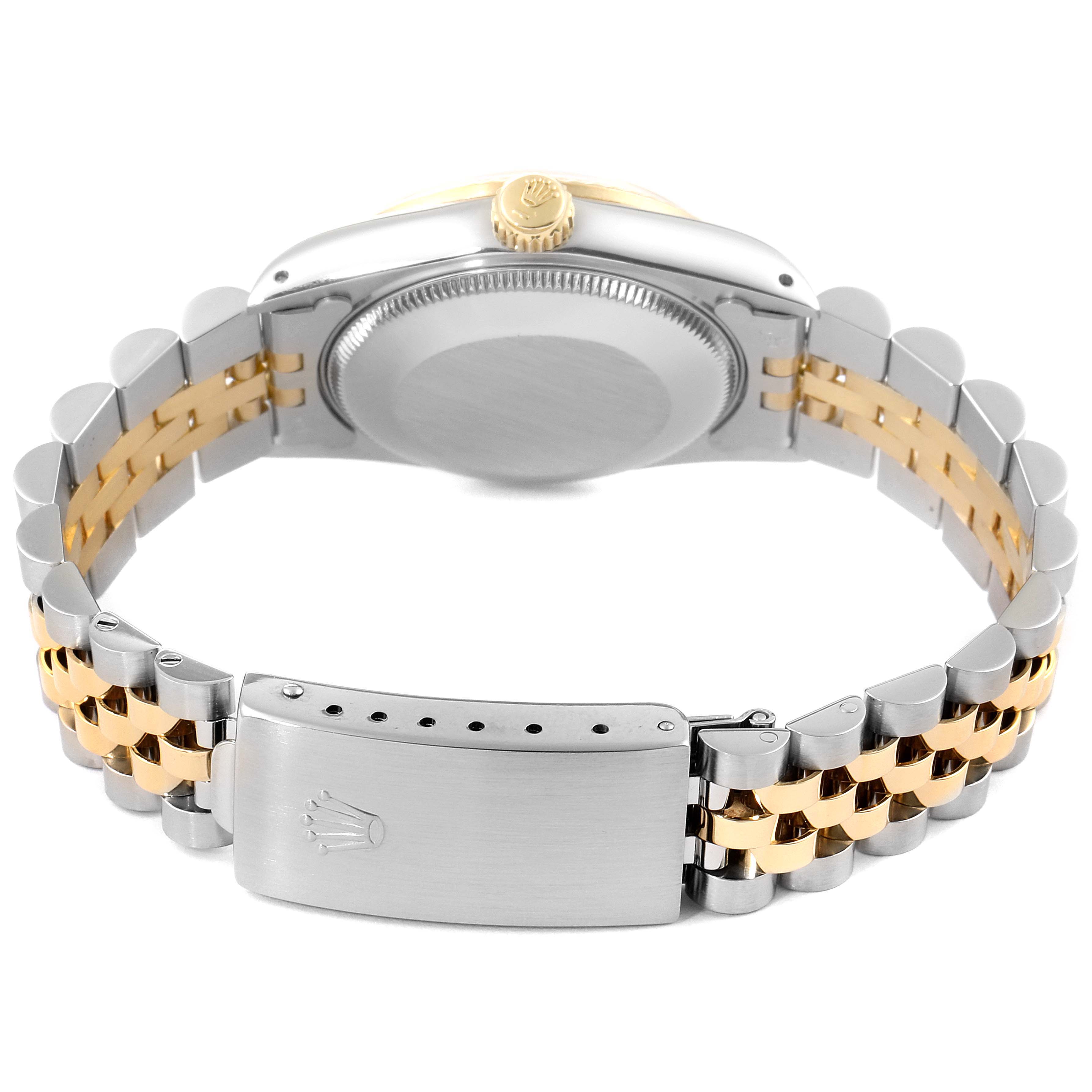 The image shows the back view of a mid-size Rolex watch, highlighting the case back, crown, and two-tone bracelet with the clasp folded open.